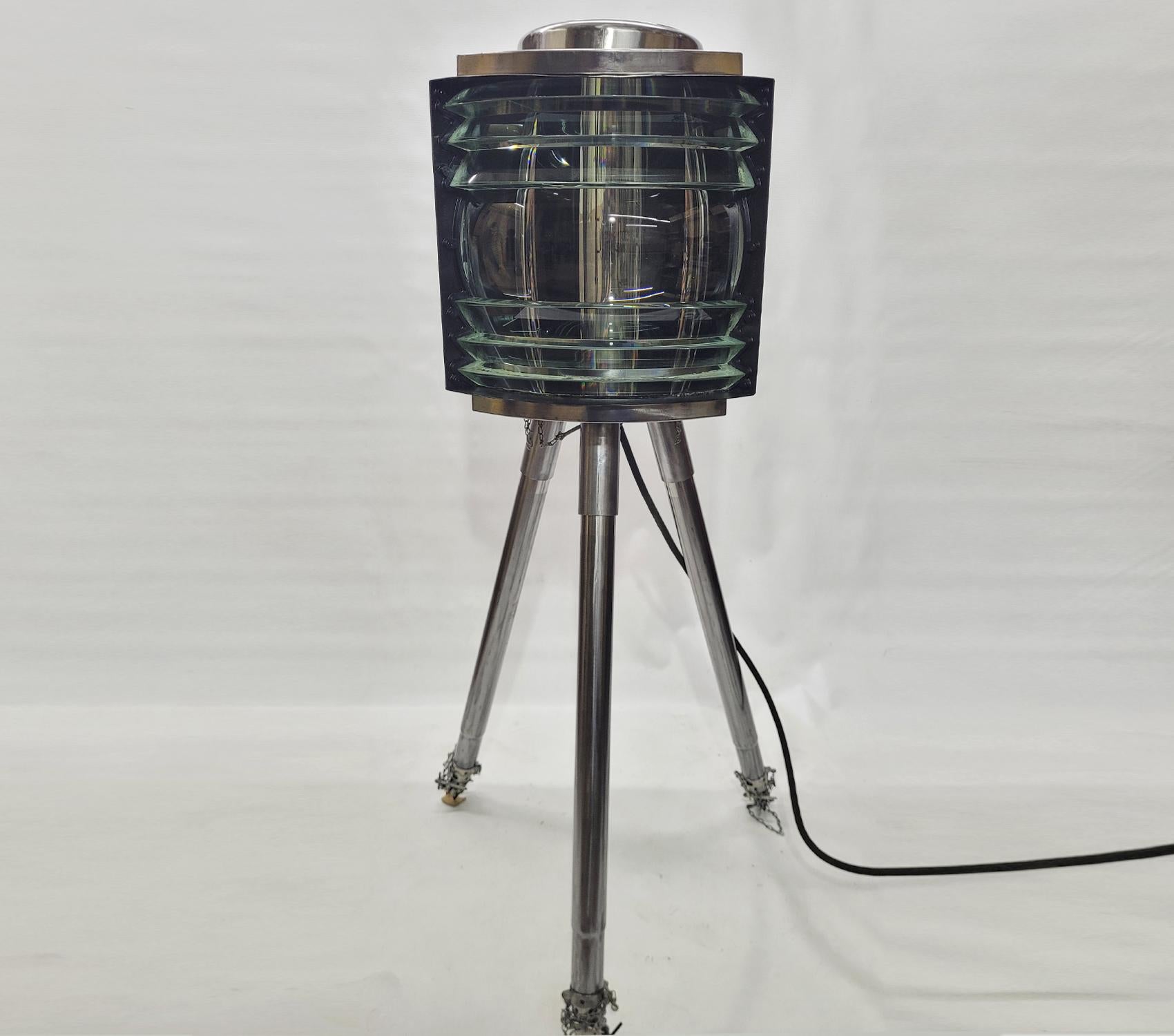 Powerful military range beacon with bulbs and sockets. Immense light beam from this meticulously polished unit. The paint has been stripped and the steel is polished. Three adjustable legs can be raised and lowered. Rewired. With original hinged