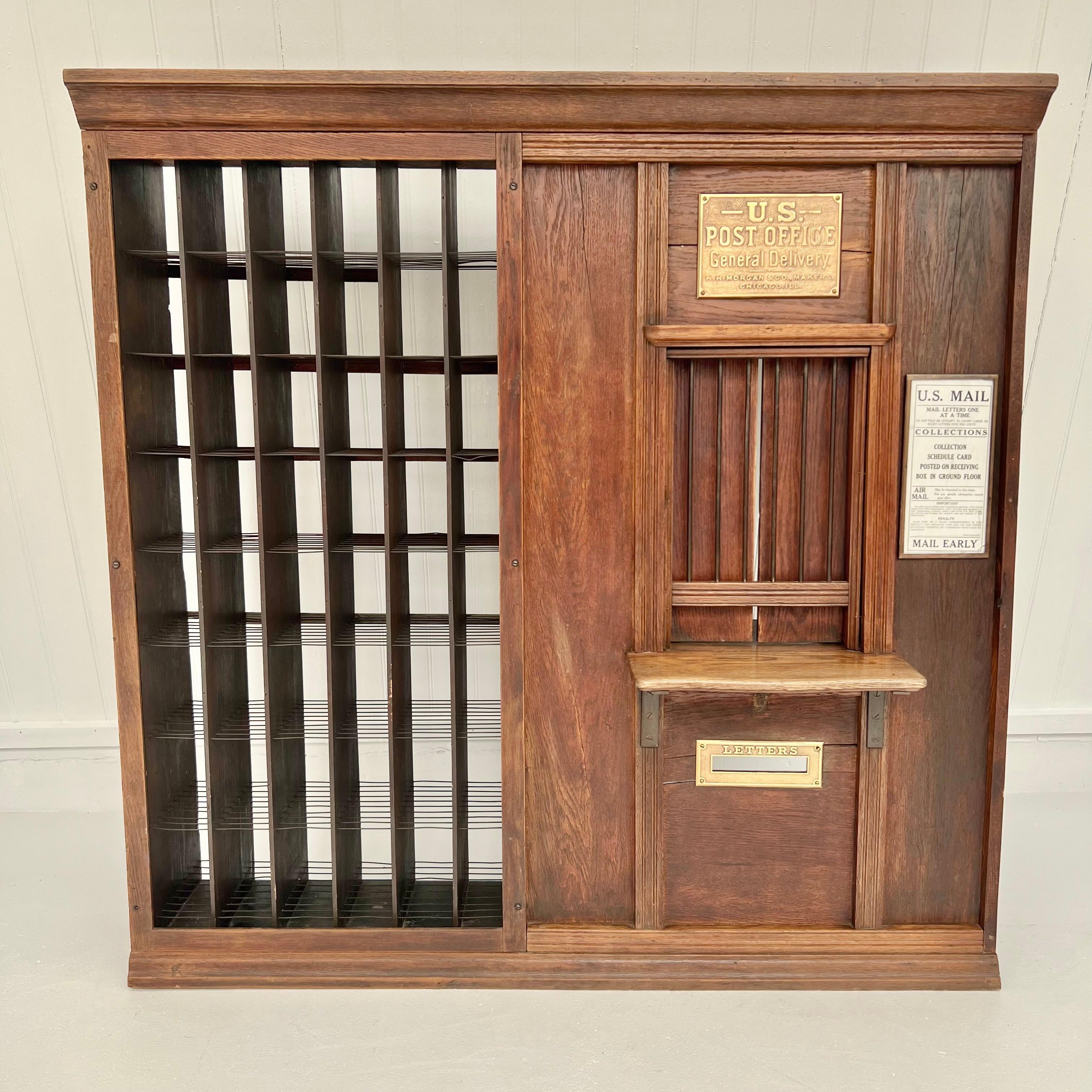 A wonderfully unique U.S. Post Office postal window with teller's cage from the late 19th century. Most likely used in a country store. Original finish oak wood. Brass plate reads 'H.H. Morgan & Co. Makers, Chicago, ILL'. Smaller oak window with