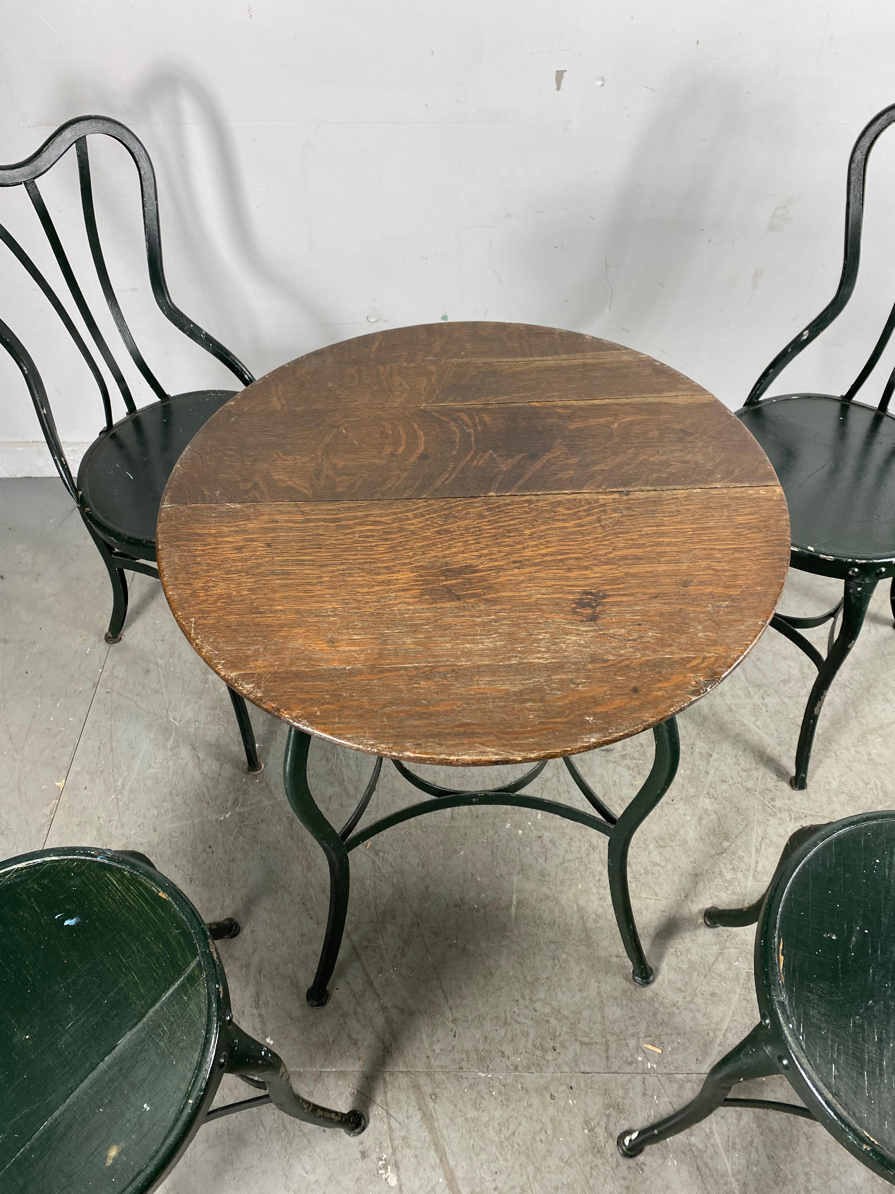 USA, 1910, vintage clement Uhl Designed art steel cafe chairs and seldom seen table manufactured by Toledo Metal Furniture Company, great little industrial set, almost Art Nouveau in design, Old paint, color. Surface. Chairs retain early 3-ply