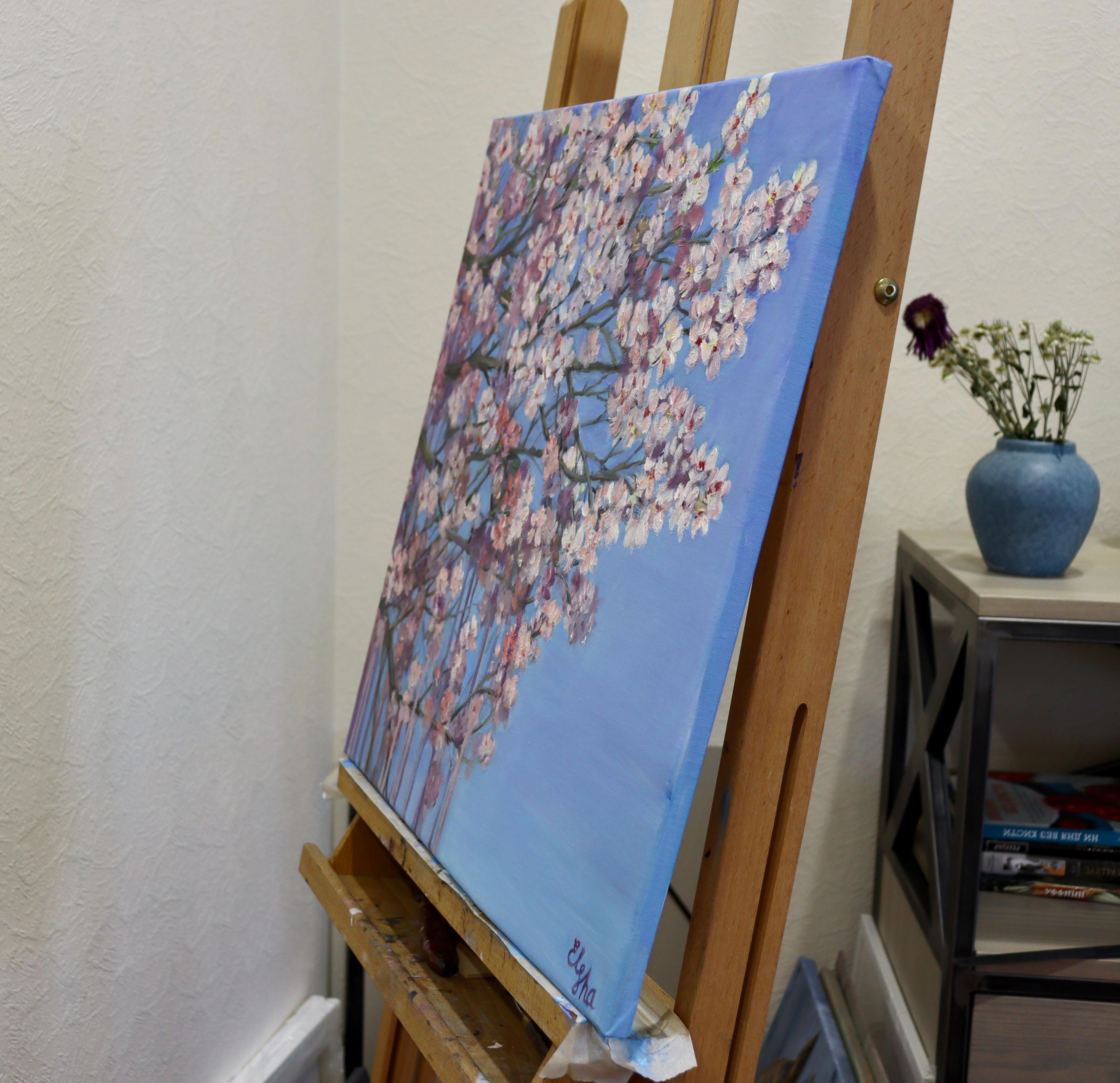 Questo dipinto a olio cattura la delicata bellezza dei fiori di melo in piena fioritura contro un cielo blu vivido. Le pennellate morbide e i colori delicati danno vita alla magia fugace della primavera, rendendo questo pezzo una scelta perfetta per