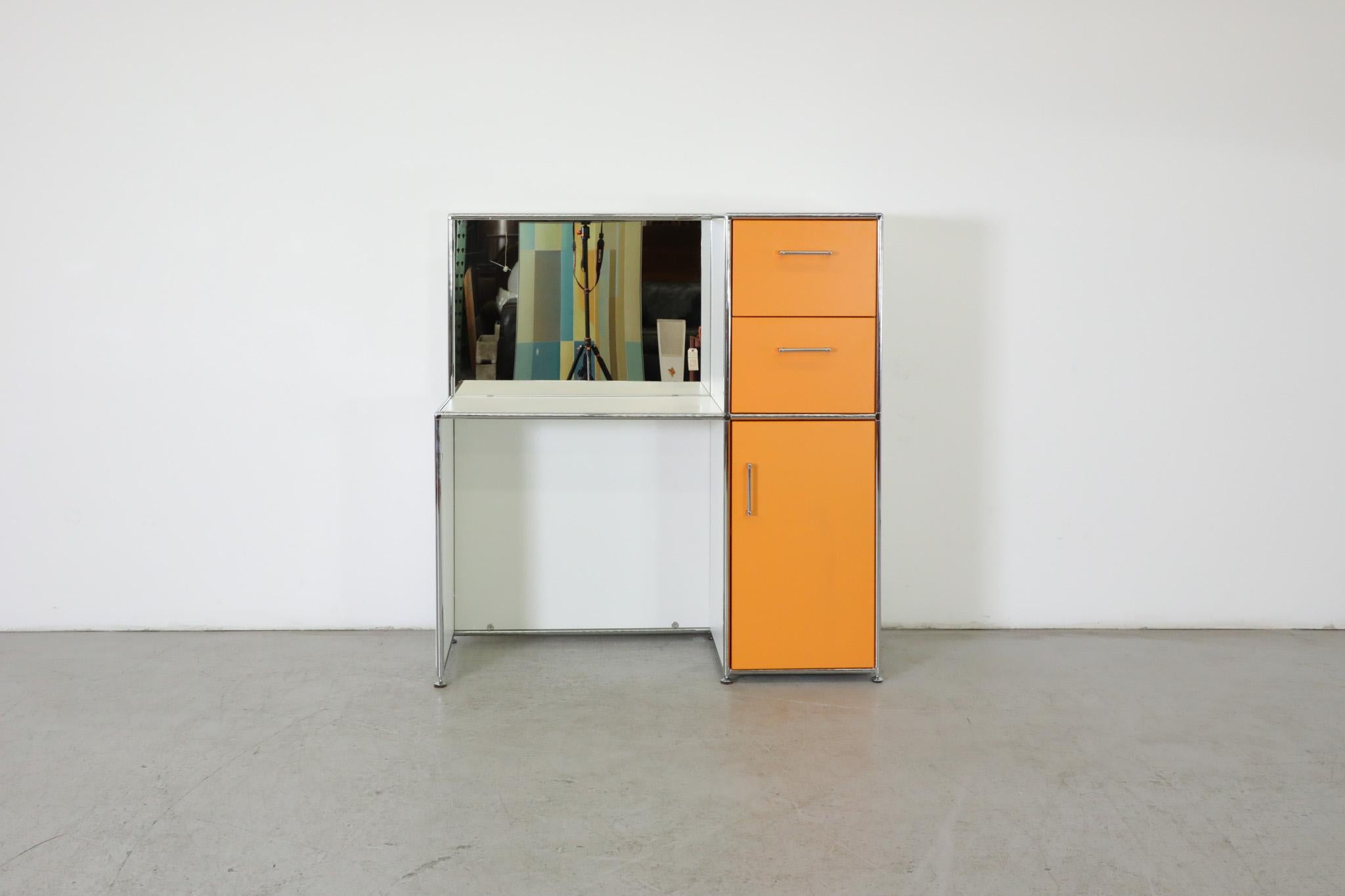Incredible white and orange vanity dressing station by Bosse. White laminate and chrome frame with square mirror and 15 x 30inch desk top. A multi-use piece with double stacked pull out drawers atop a large storage cabinet all with metal enameled