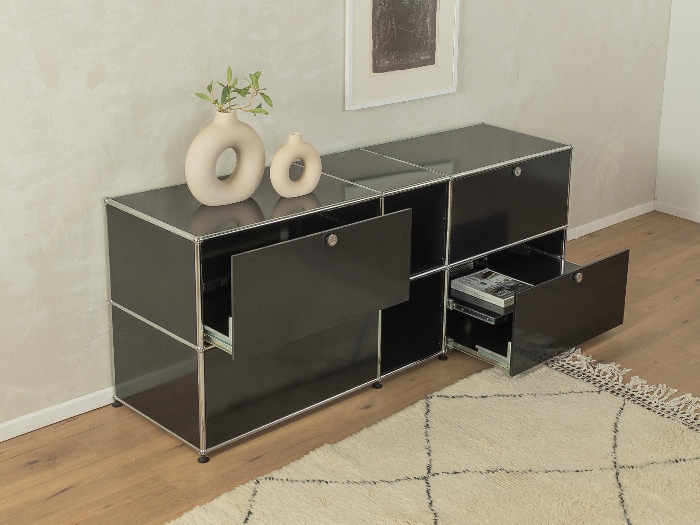Classic sideboard from the Haller modular system by Fritz Haller for USM from the 1960s. High-quality stainless steel frame in black with 4 drawer doors and 4 pull-out, internal drawers.

Quality Features:
very good workmanship
high quality