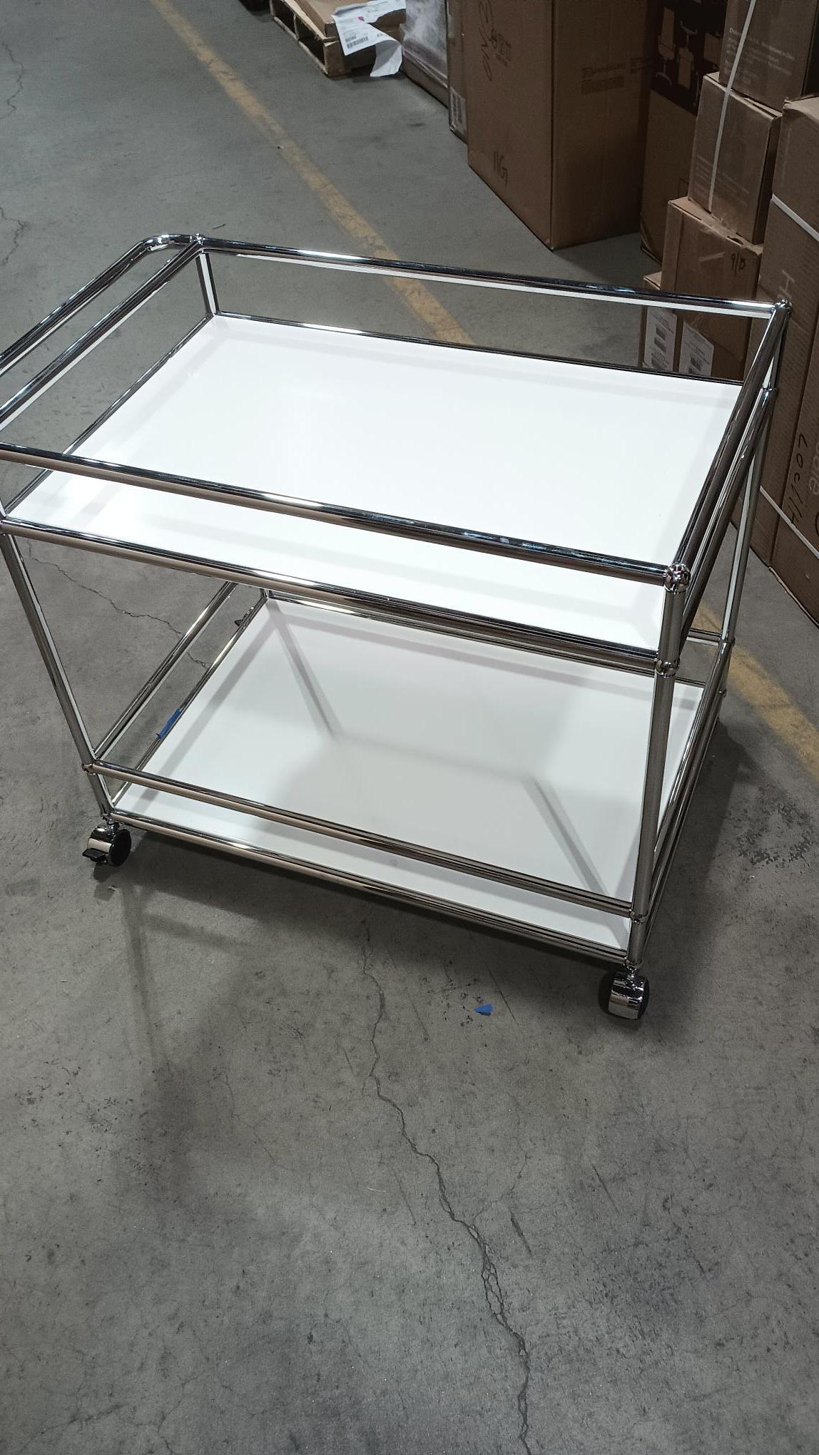 
USM Haller Serving Cart L18

31”W 21”D 28”H
polished chrome frame
with handle and casters
Finish: Pure white .24
This modern bar cart offers plenty of space for all your entertaining and storage needs. . Designed by Swiss architect Fritz Haller and