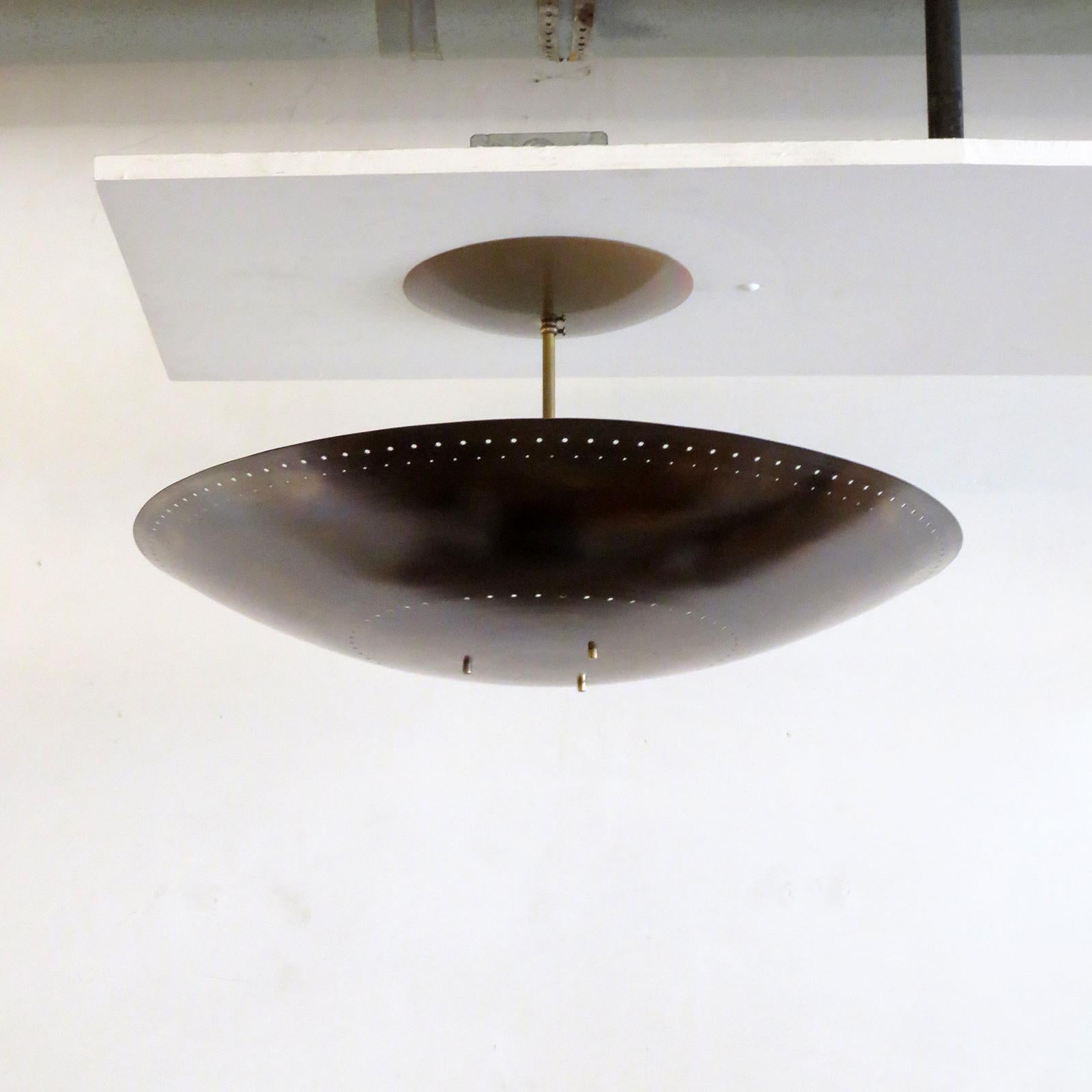 Large-scale ceiling flushmount light Utah-24 designed by Gallery L7, handcrafted and finished in Los Angeles from American brass, suspended perforated raw, aged brass disc (24inch diameter). Six E12 sockets per fixture, max. wattage 40w each, wired