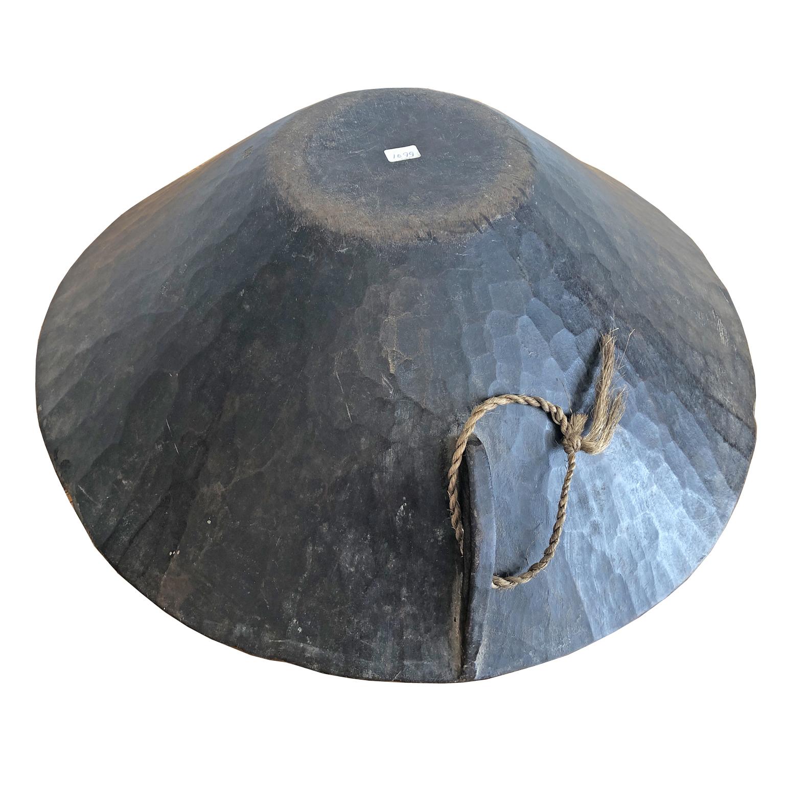 A beautiful dark, chocolate-colored wooden bowl made by the Gala or Karo people in Southern Ethiopia and carved out of a solid block of wood, it served as a utilitarian object in everyday tribal life (and was not made for commercial sale, which