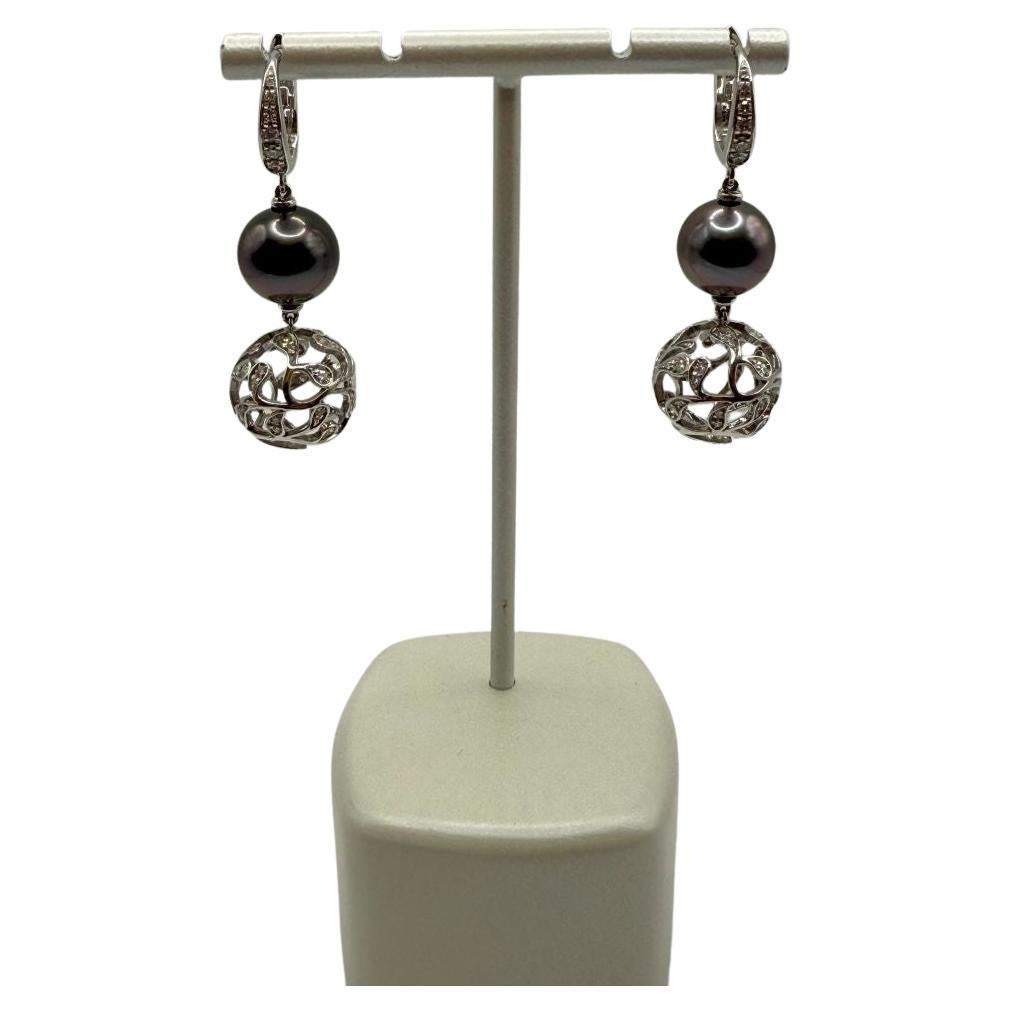 The Utopia Bolero earrings are a striking pair that combine opulence with modern sophistication. Crafted in 18kt white gold, these earrings showcase 11mm Tahitian pearls, known for their captivating color and unique iridescence. The Tahitian pearls,