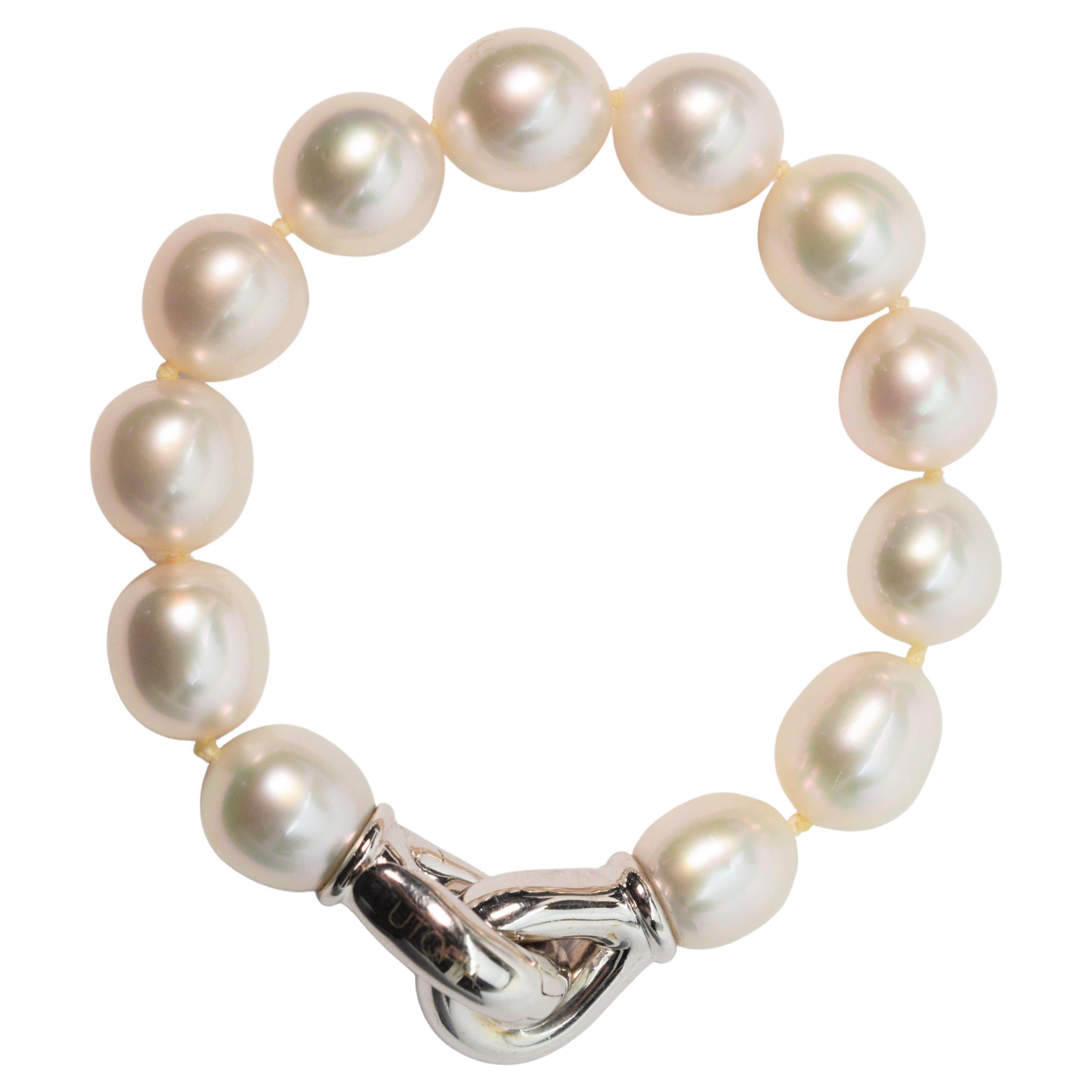 Impeccable Italian contemporary design by Paolo Gaia for UTOPIA Milan, this stunning bracelet has twelve carefully selected lustrous white South Sea pearls that are hand strung and knotted on this sleek version of a classic. With a stylized