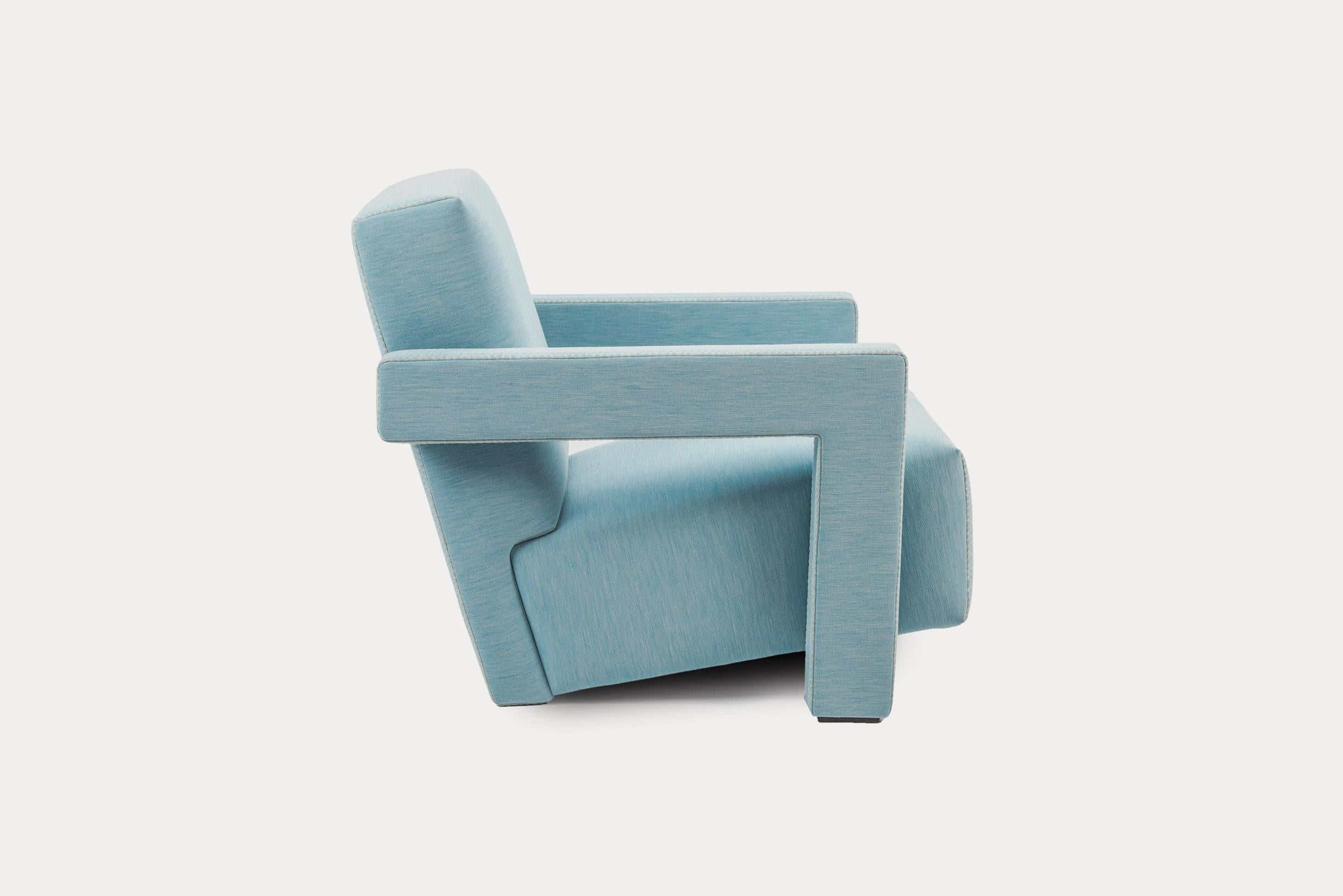 Armchair with main frame, seat and backrest in poplar plywood and fir solid wood. Massive poplar wood armrests. Polyurethane foam and polyester padding. Soft light blue non-removable fabric with blanket fine stitching in natural colour. Feet in