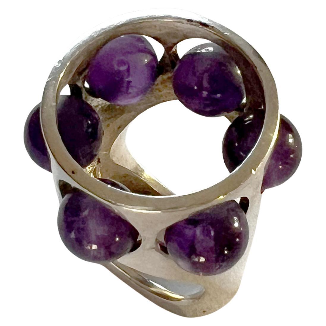 Sterling silver and amethyst ring designed by Danish modernist jeweler, Uwe Helmut Moltke.  Bold in design and scale, ring is a finger size 7 and sits about 1/2