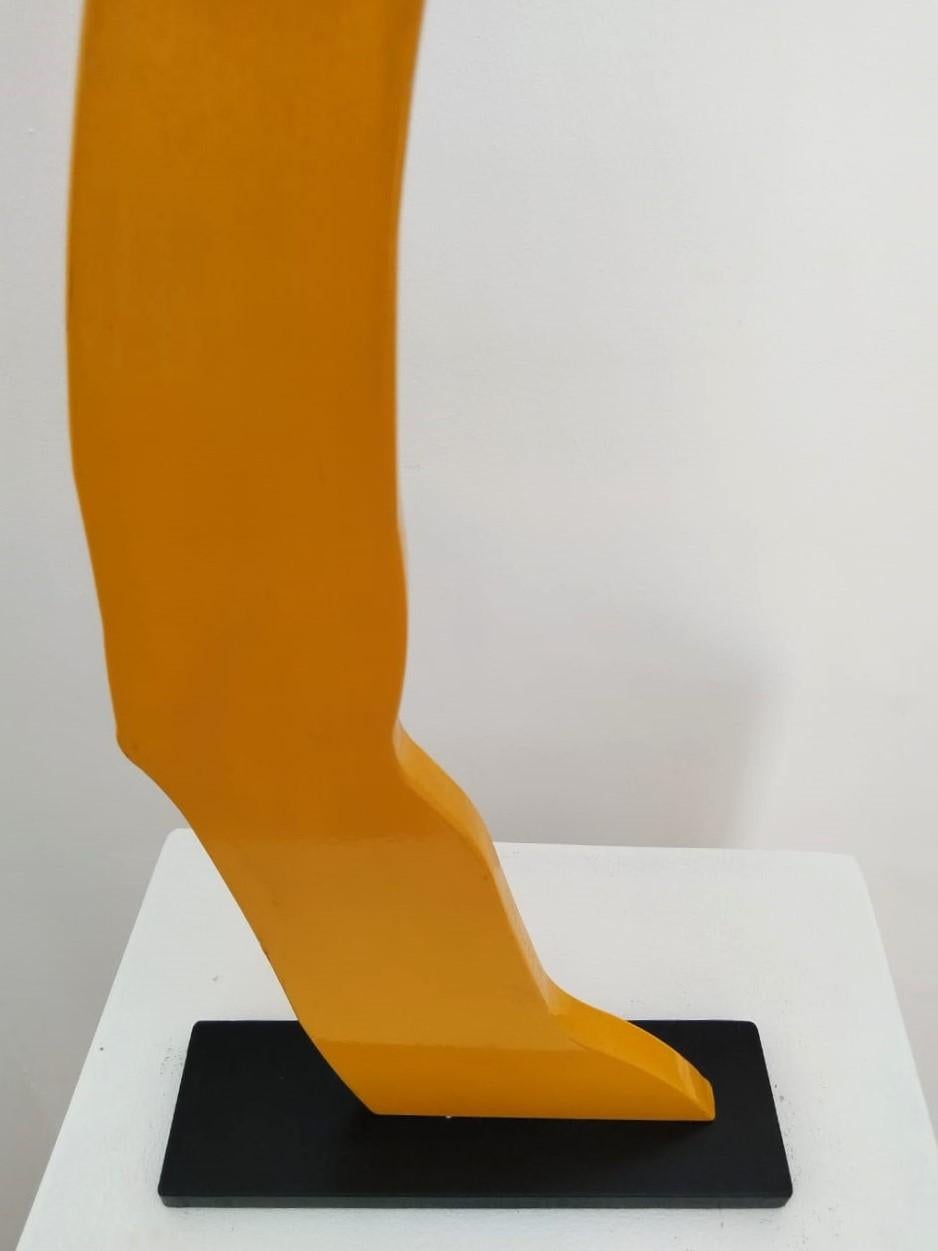 A limited edition, yellow powder coated mild steel sculpture on a black steel base. The sculpture is typical to Uwe Pfaff's tongue in cheek approach, depicting a human arm showing a peace sign. Edition 1/5. Available in different colours on request.