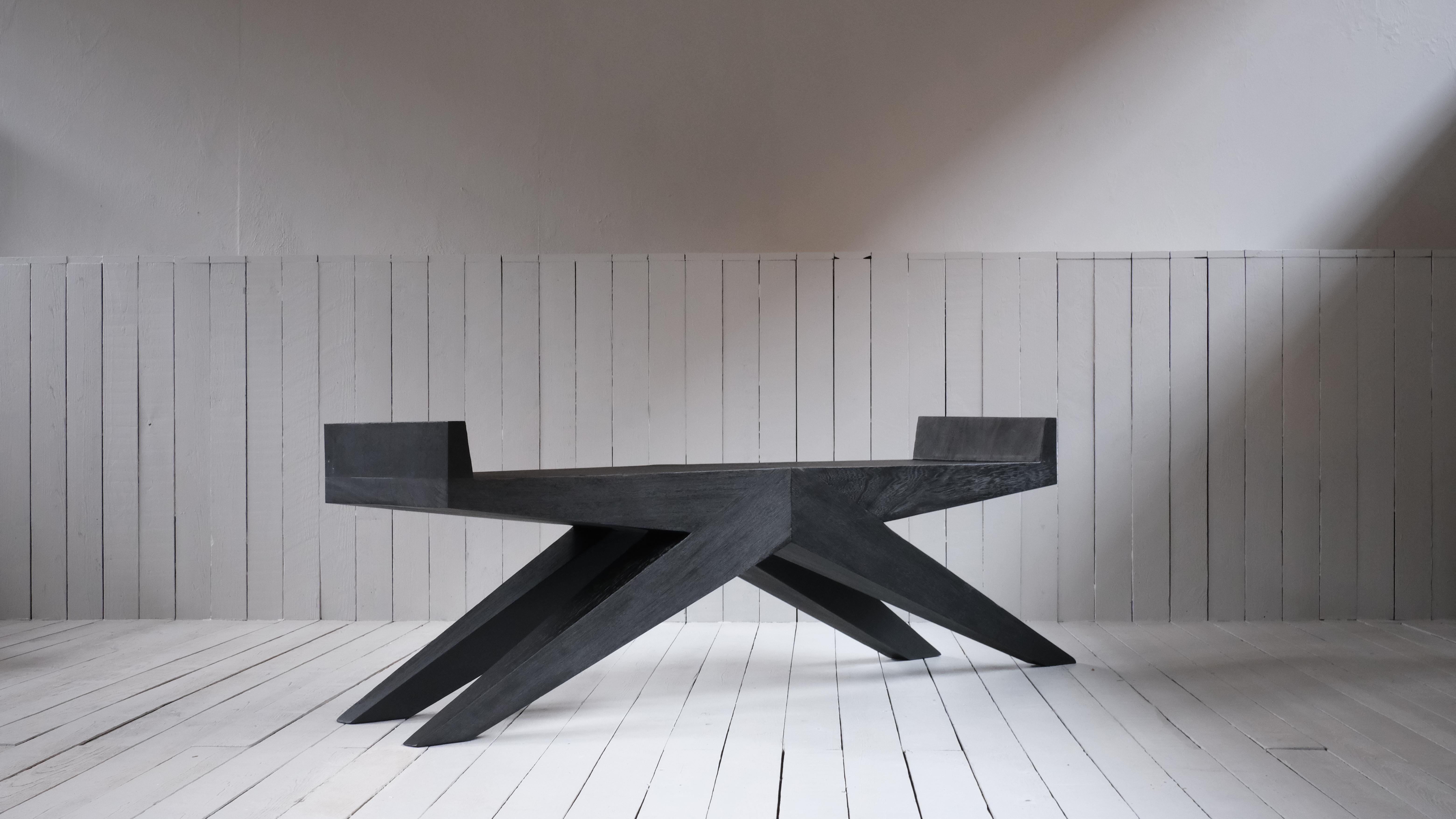 V-bench in Iroko wood by Arno Declercq
Dimensions: W 180 x D 38 x H 55 cm 
Materials: burned and waxed Iroko wood

Arno Declercq
Belgian designer and art dealer who makes bespoke objects with passion for design, atmosphere, history and craft.