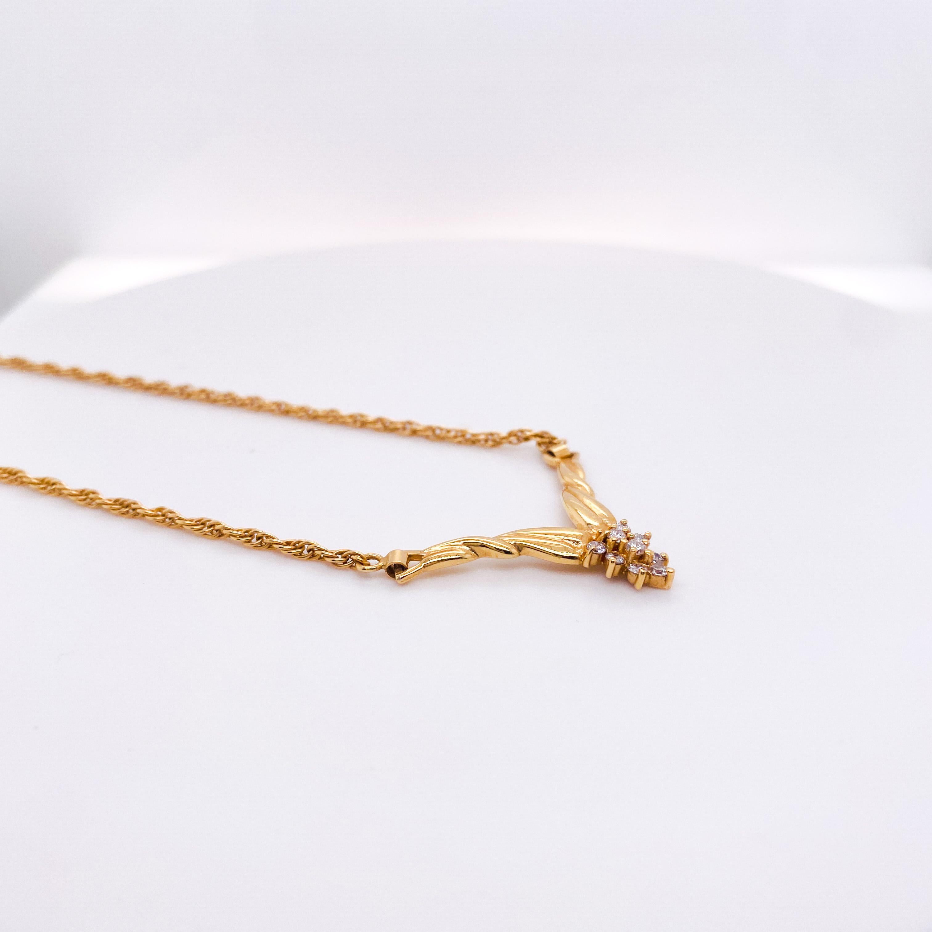 The 14 karat yellow gold chevron diamond necklace looks perfect on any neck. The rope chain is soldered to a V-shape design of gold accented at the base of the V with nine diamonds in a pear shape cluster. The diamonds weigh .35 carats total weight.