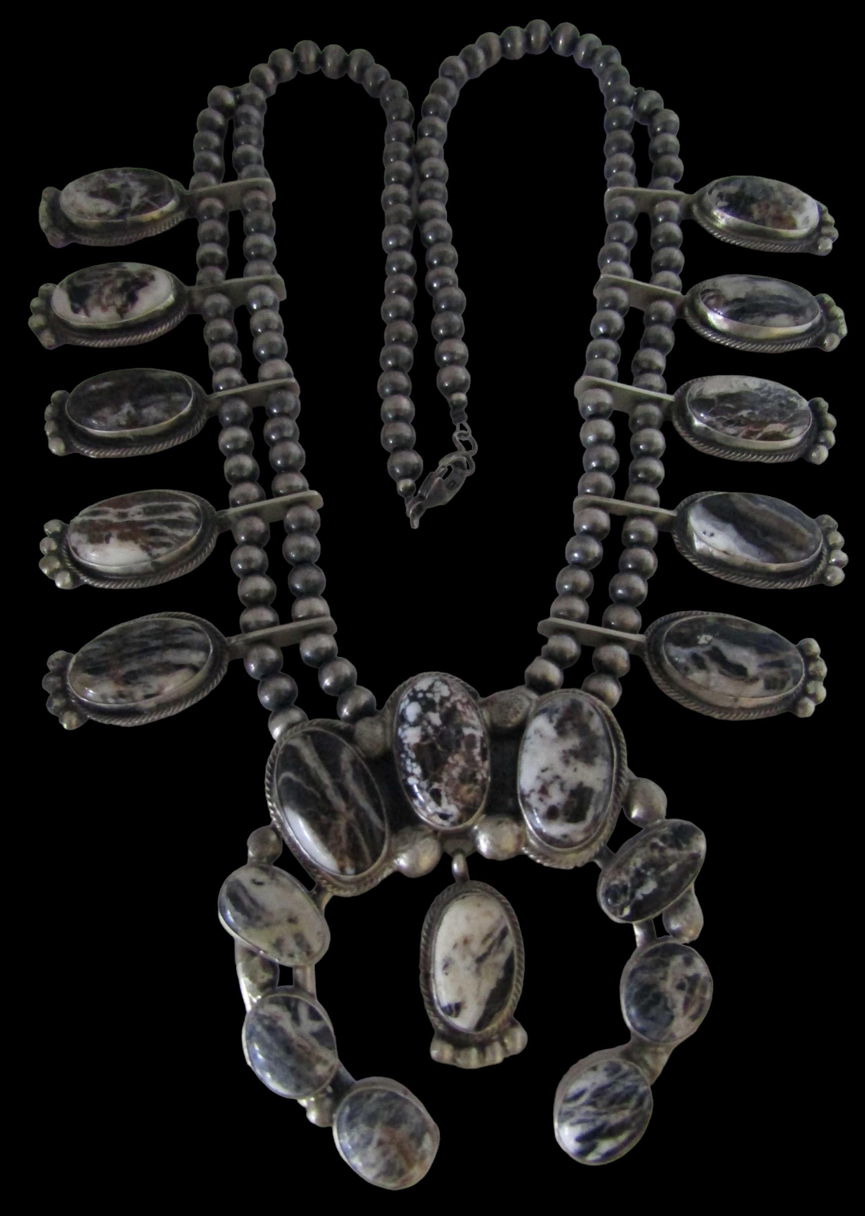 This Navajo Wild Horse, White Buffalo and Sterling Silver Squash Blossom necklace, signed by Native American Victor Hicks, is one of a kind and highly desirable. This brilliant silversmith has been creating beautiful artisan pieces for nearly 40