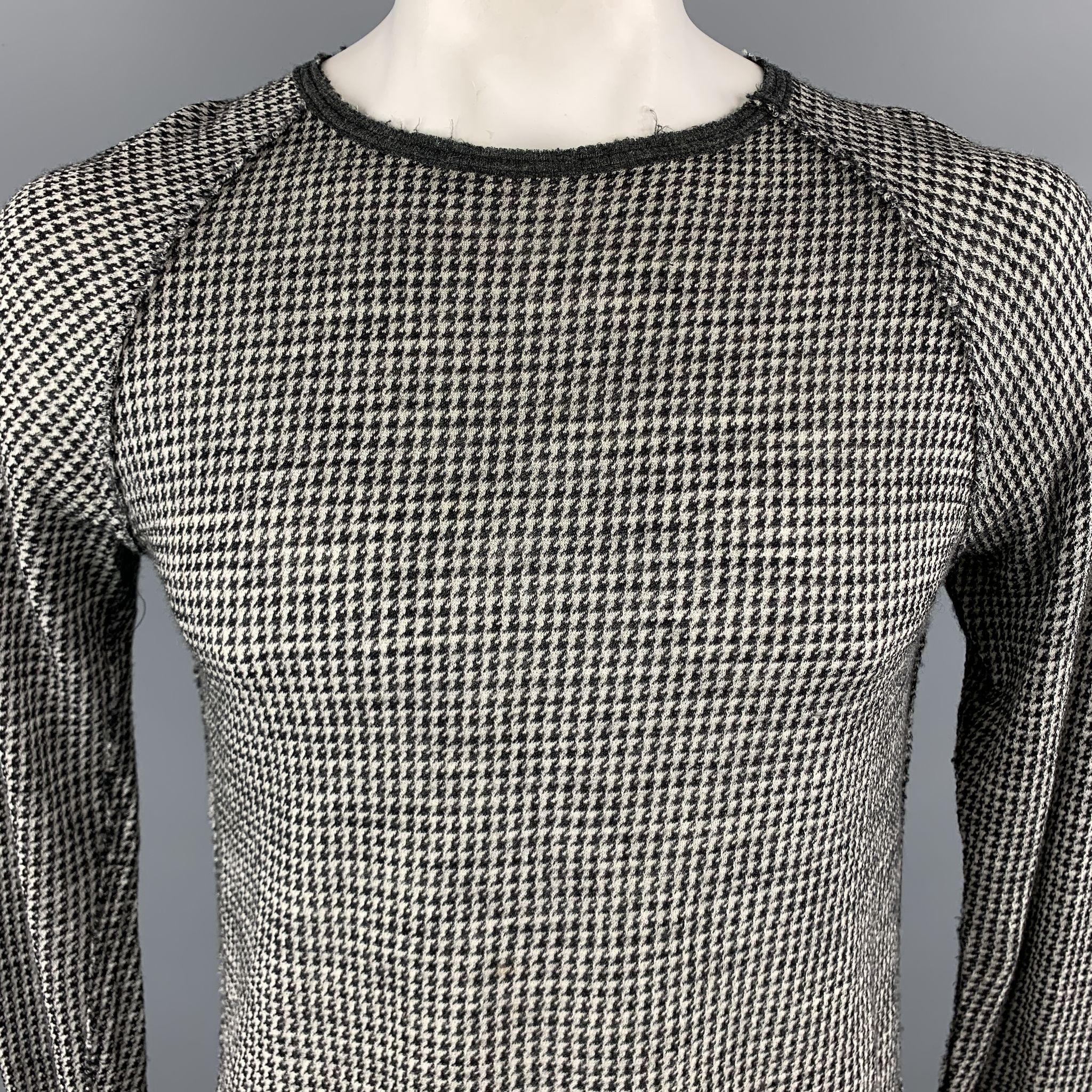 V::ROOM Pullover Sweater comes in black and grey tones in a houndstooth wool material, with a crewneck, raglan sleeves and raw hem. As is, with a small hole at front. Made in Japan.

Good Pre-Owned Condition.
Marked: L

Measurements:

Shoulder: 17.5