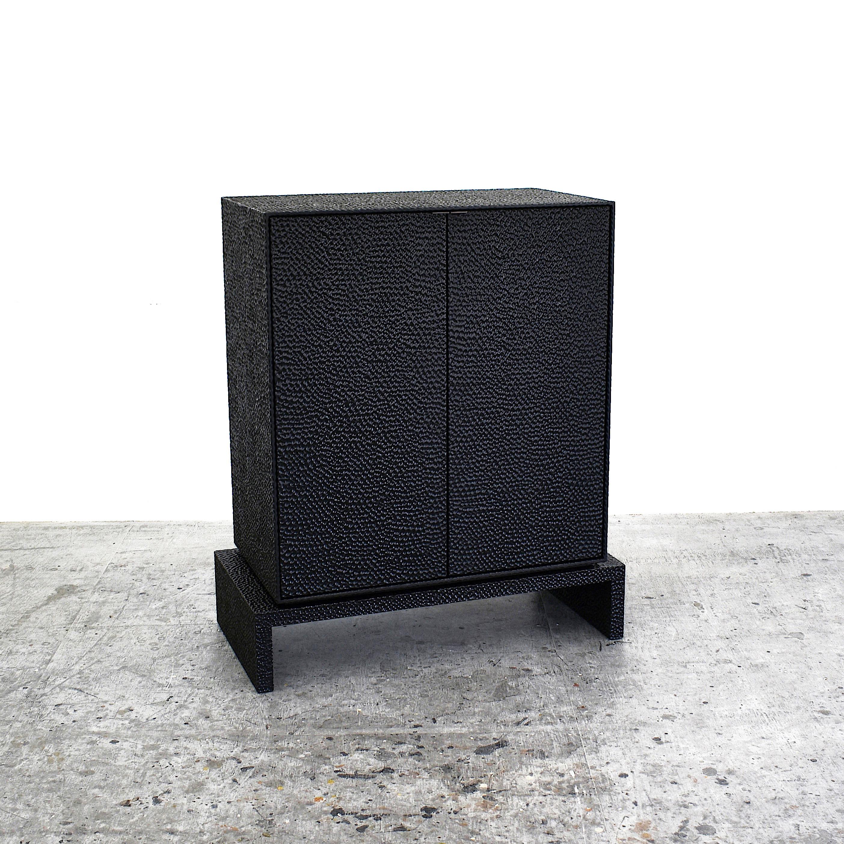 V2 cabinet sculpted by John Eric Byers
Dimensions: 106.7 x 91.5 x 45.7 cm
Materials: carved blackened maple and brass

All works are individually handmade to order.

John Eric Byers creates geometrically inspired pieces that are minimal,