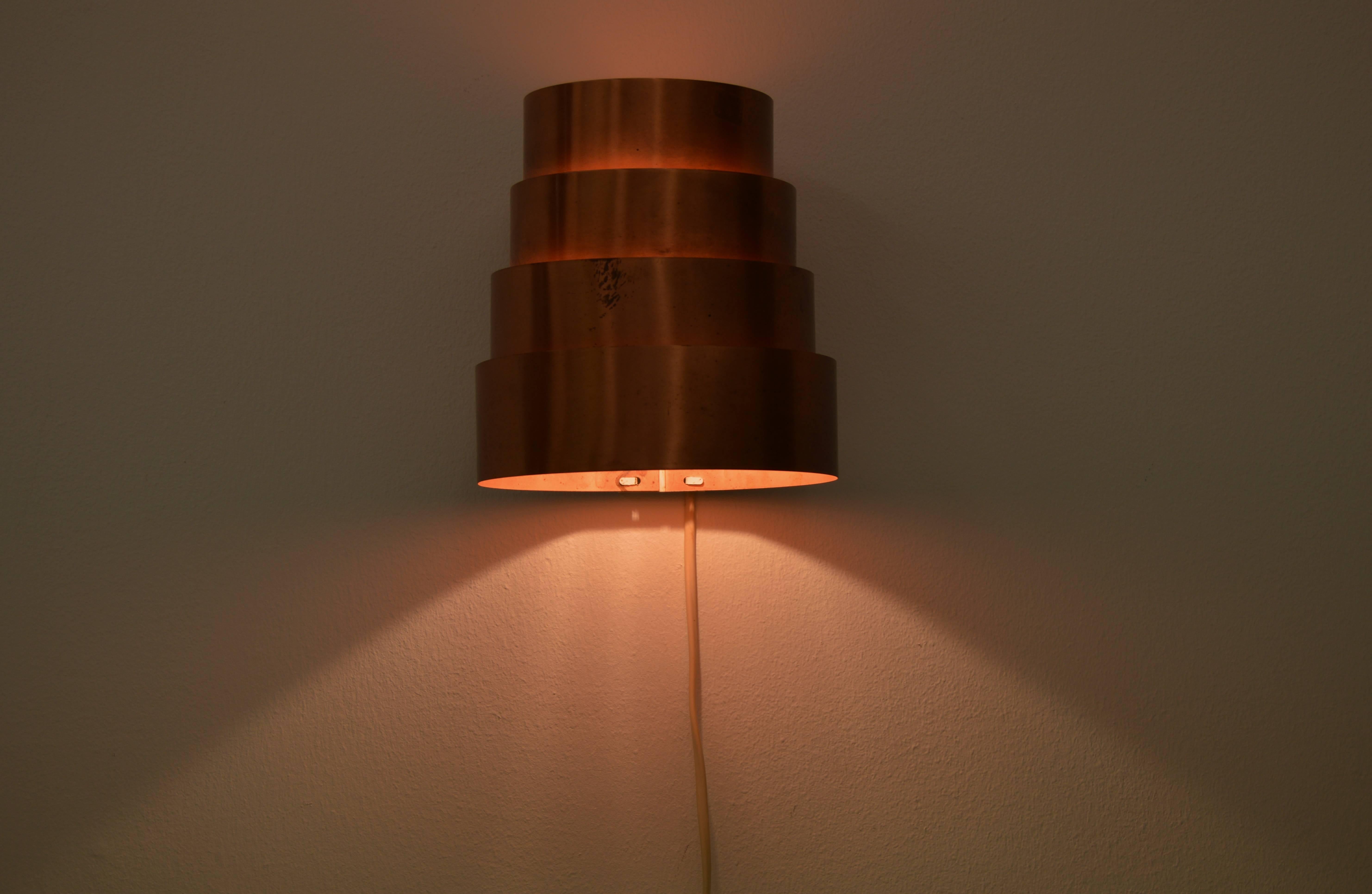 Copper wall lamp designed by Hans-Agne Jakobson.
Four circles of increasing size.