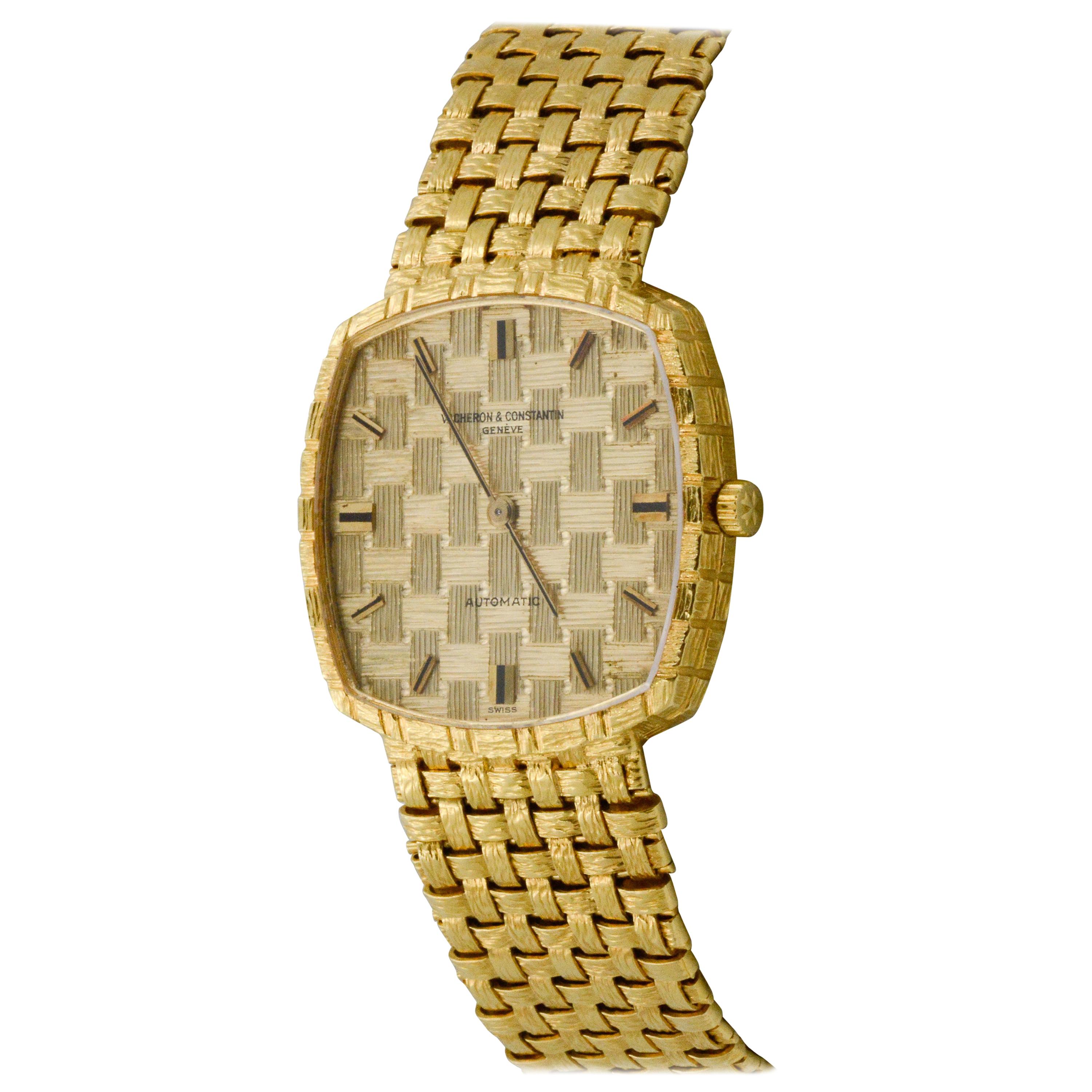 From Vacheron Constantin, this 1970s 18 karat yellow gold watch has a unique square case with a basket weave pattern index dial. The watch also has a textured basket weave bracelet and automatic movement. 
