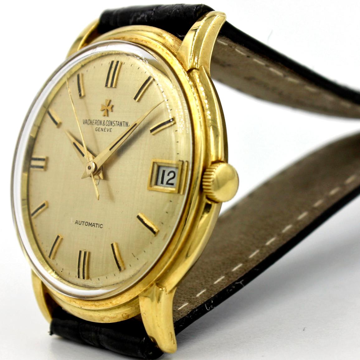 Vintage Vacheron Constantin Quantieme automatic wrist watch for men in 18 karat yellow gold on black leather strap. Circa 1960's. Round case. Acrylic crystal. Gold textured dial with black and gold stick hour markers. Dauphine style hands. Powered