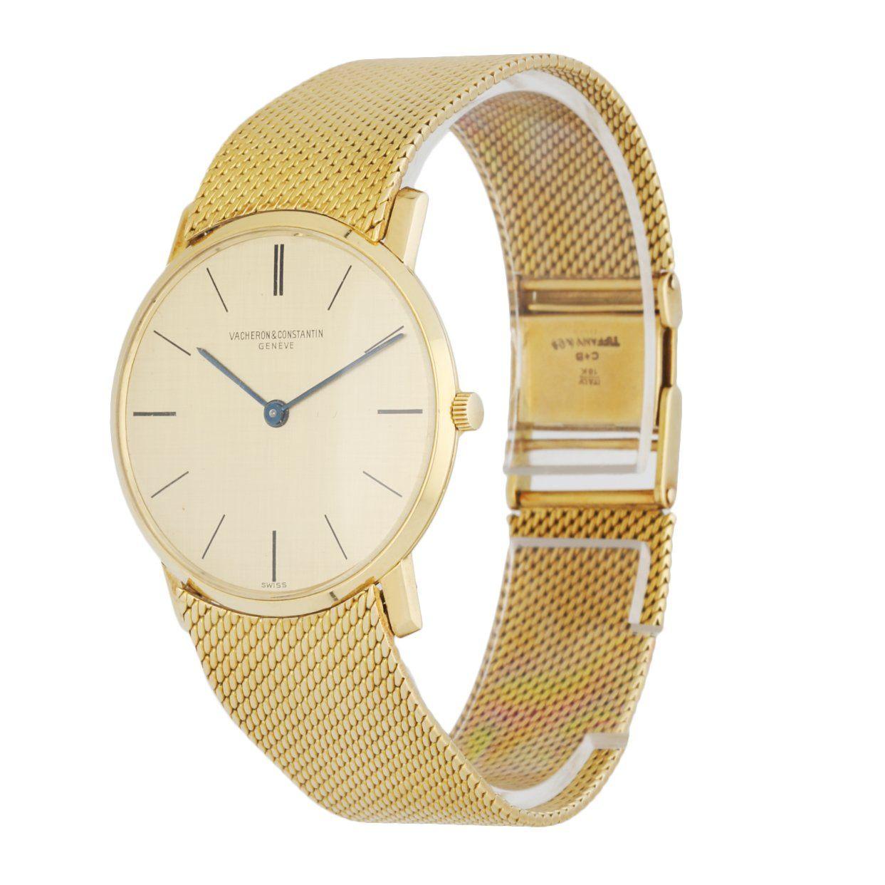 Vacheron Constantin 6872 men's watch. 31.5MM 18K yellow gold case with 18K yellow gold smooth bezel. Champagne dial with black hands and index hour marker. 18K yellow gold mesh bracelet with 18K yellow gold jewelry clasp. Will fit up to 6.75-Inch