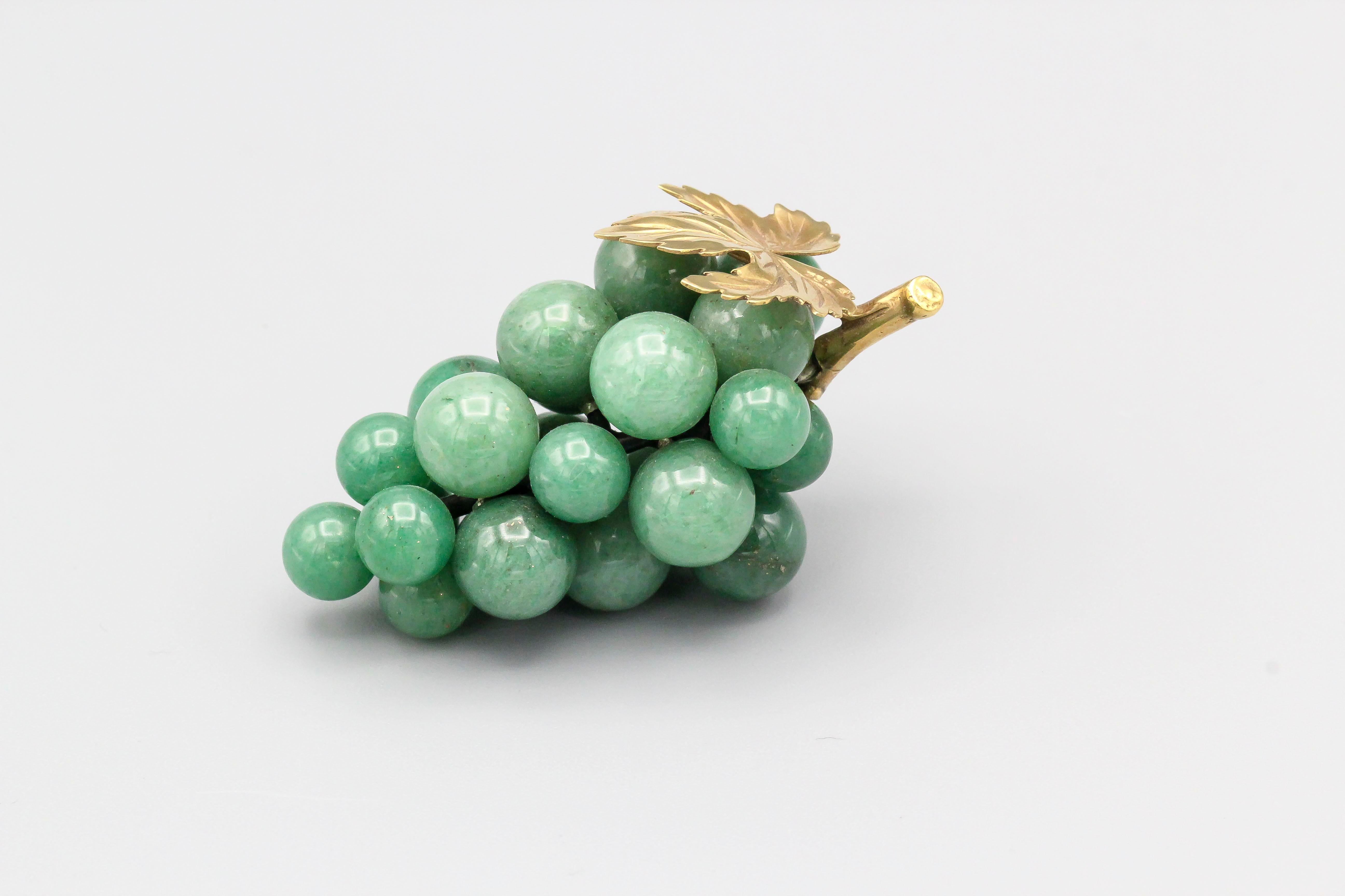 Fine aventurine and 18k yellow gold grapes paperweight by Vacheron Constantin. It resembles the actual fruit quite accurately, with gold as the top leaf and stem.

Hallmarks: Vacheron Constantin maker's mark, 750.
