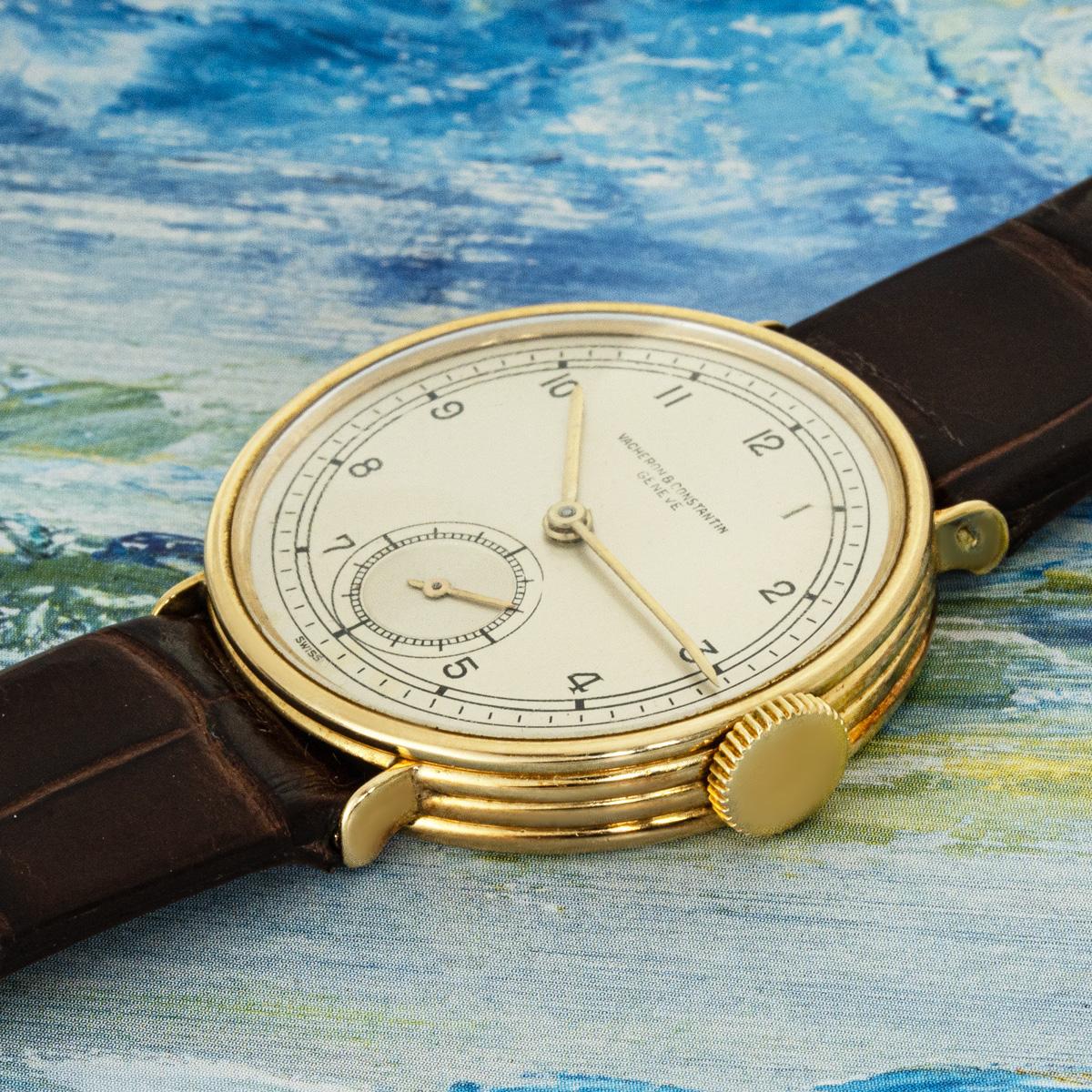 A vintage mens dress watch in yellow gold by Vacheron Constantin. Featuring a silver dial with Arabic numbers and a small seconds display. Fitted with plastic glass, a manual wind movement, and a new generic brown leather strap set with a generic