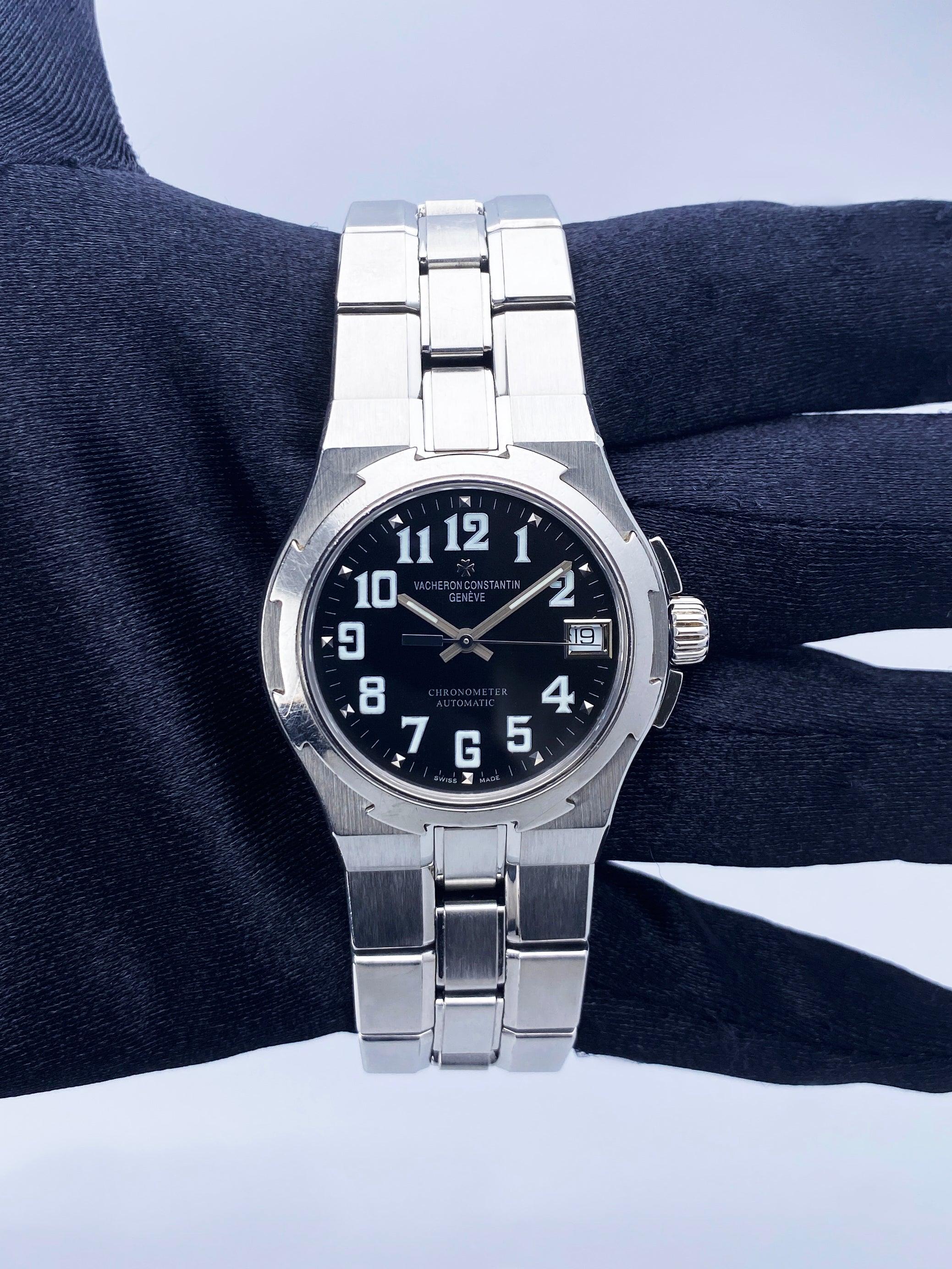 Vacheron Constantin Overseas 42050 Mens Watch. 35mm stainless steel case with stainless steel bezel. Black dial with luminous steel hands and Arabic numeral hour markers. Minute makers on the outer dial. Date display at 3 o'clock position. Stainless