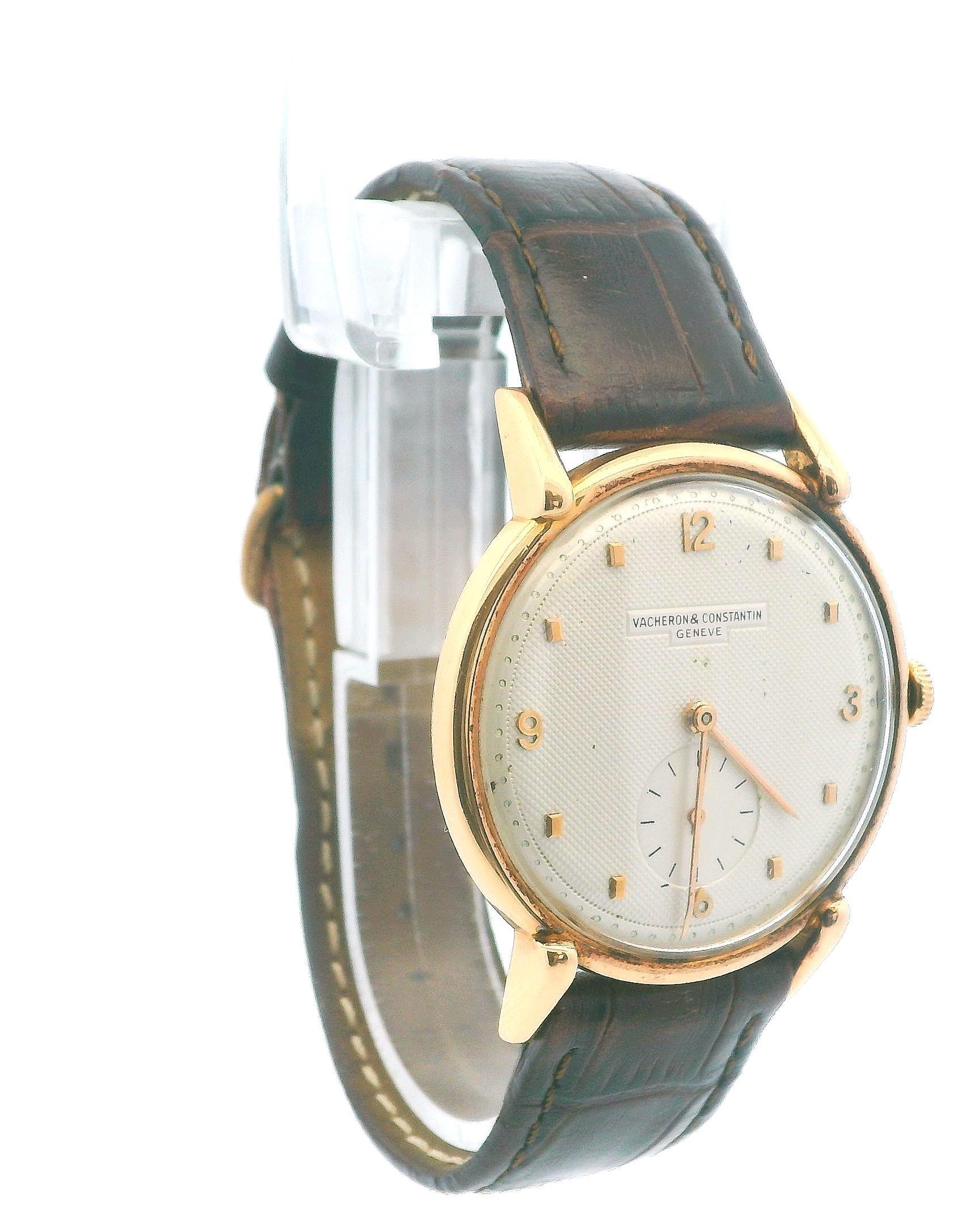 This vintage Vacheron Constantin timepiece is a remarkable blend of elegance and craftsmanship, crafted from 18k rose gold with a smooth, round case featuring a refined bezel. The textured silver dial, adorned with clear Arabic numerals, presents a