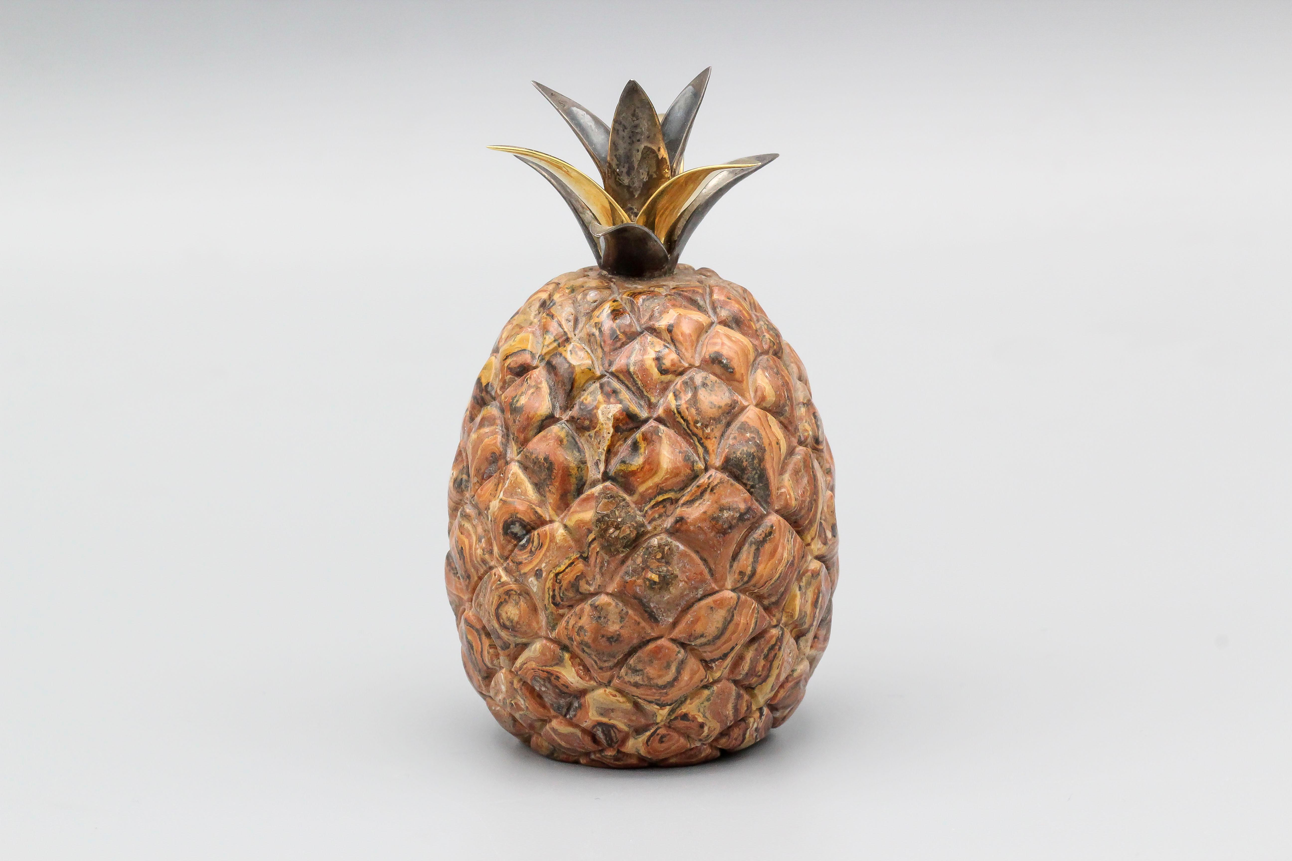 Fine petrified wood, silver, and 18k yellow gold pineapple paperweight by Vacheron Constantin. It resembles the actual fruit quite accurately, with gold and silver as the top leaves.

Hallmarks: Vacheron Constantin maker's mark, 750, 925.