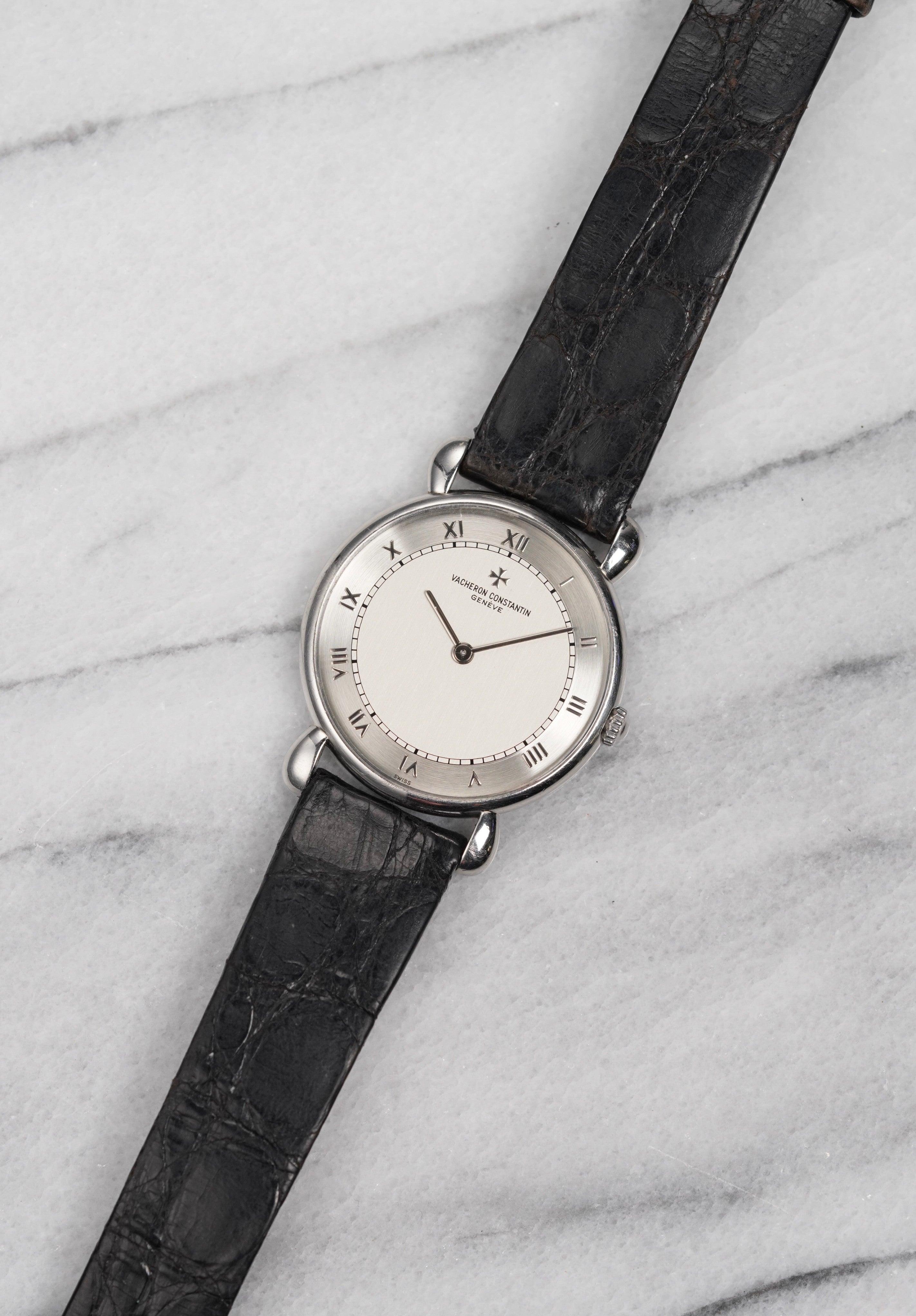 Ecco un Vacheron Constantin a carica manuale in platino con quadrante in argento a numeri romani bicolore degli anni '90. Le misure includono una cassa di 33 mm e una larghezza delle anse di 16 mm. Con il suo cinturino originale in pelle nera e la