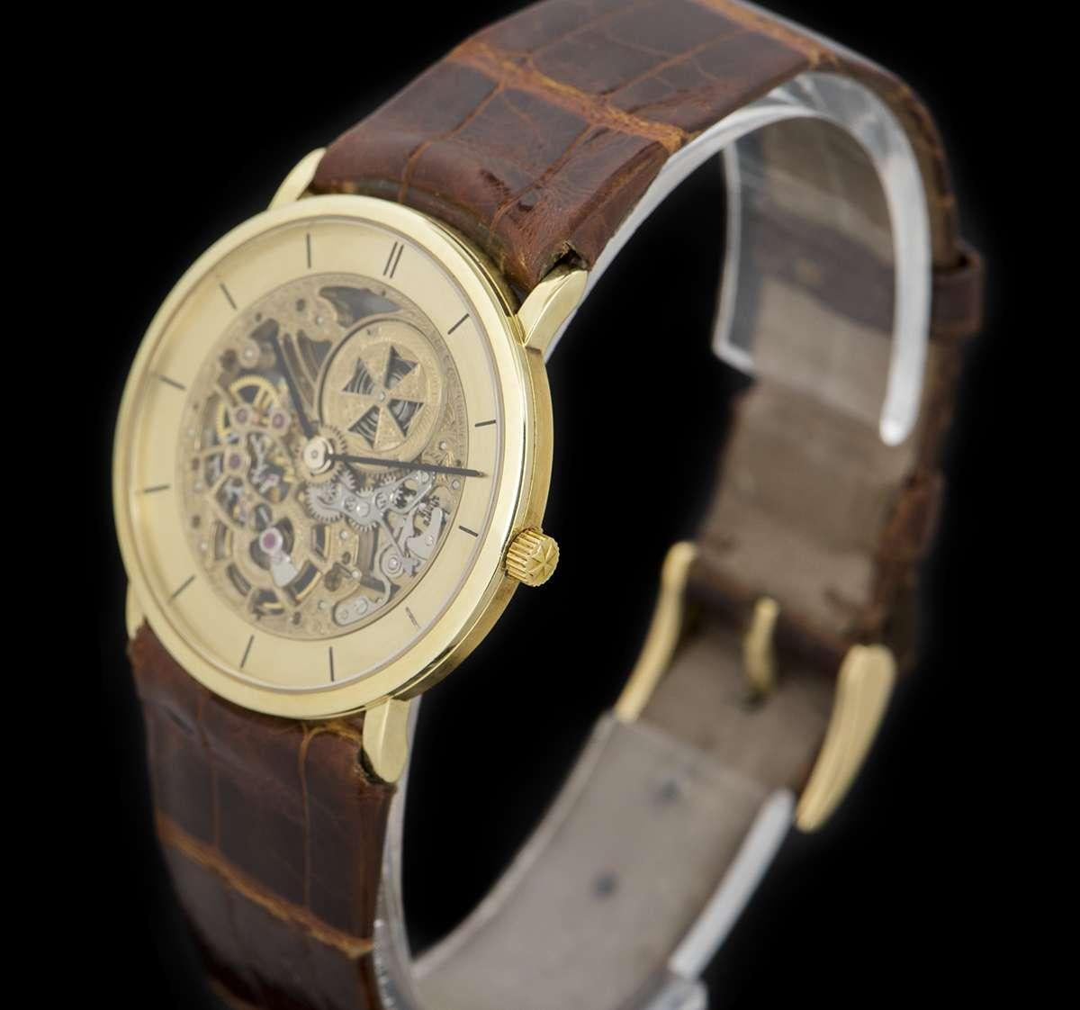 An 18k Yellow Gold Squelette Gents Wristwatch, champagne skeleton dial with hour markers, a fixed 18k yellow gold bezel, an original brown leather strap with an original 18k yellow gold pin buckle, sapphire glass, exhibition caseback, manual wind