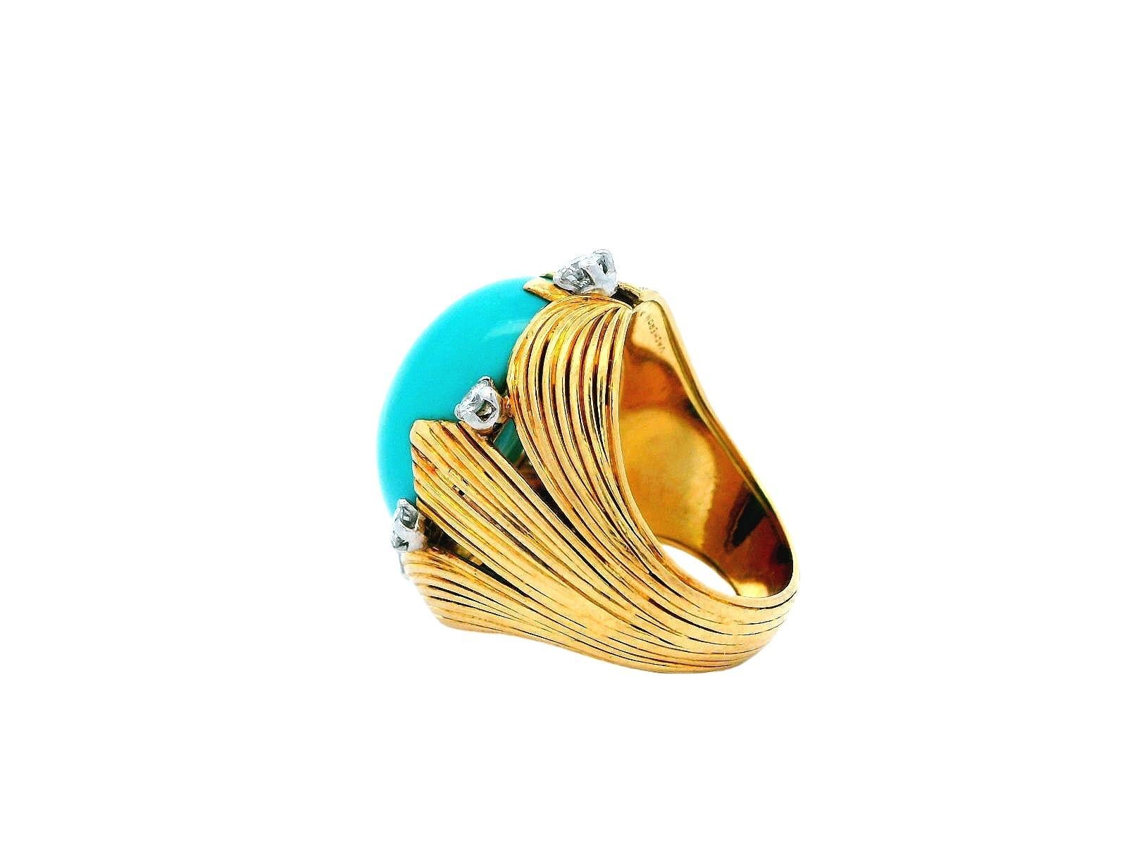This exquisite ring showcases a stunning 16.0-carat cabochon turquoise, radiating a striking vivid blue that captures the eye. The centerpiece is beautifully surrounded by a halo of round white diamonds—totaling 0.72 carats—each featuring a clarity