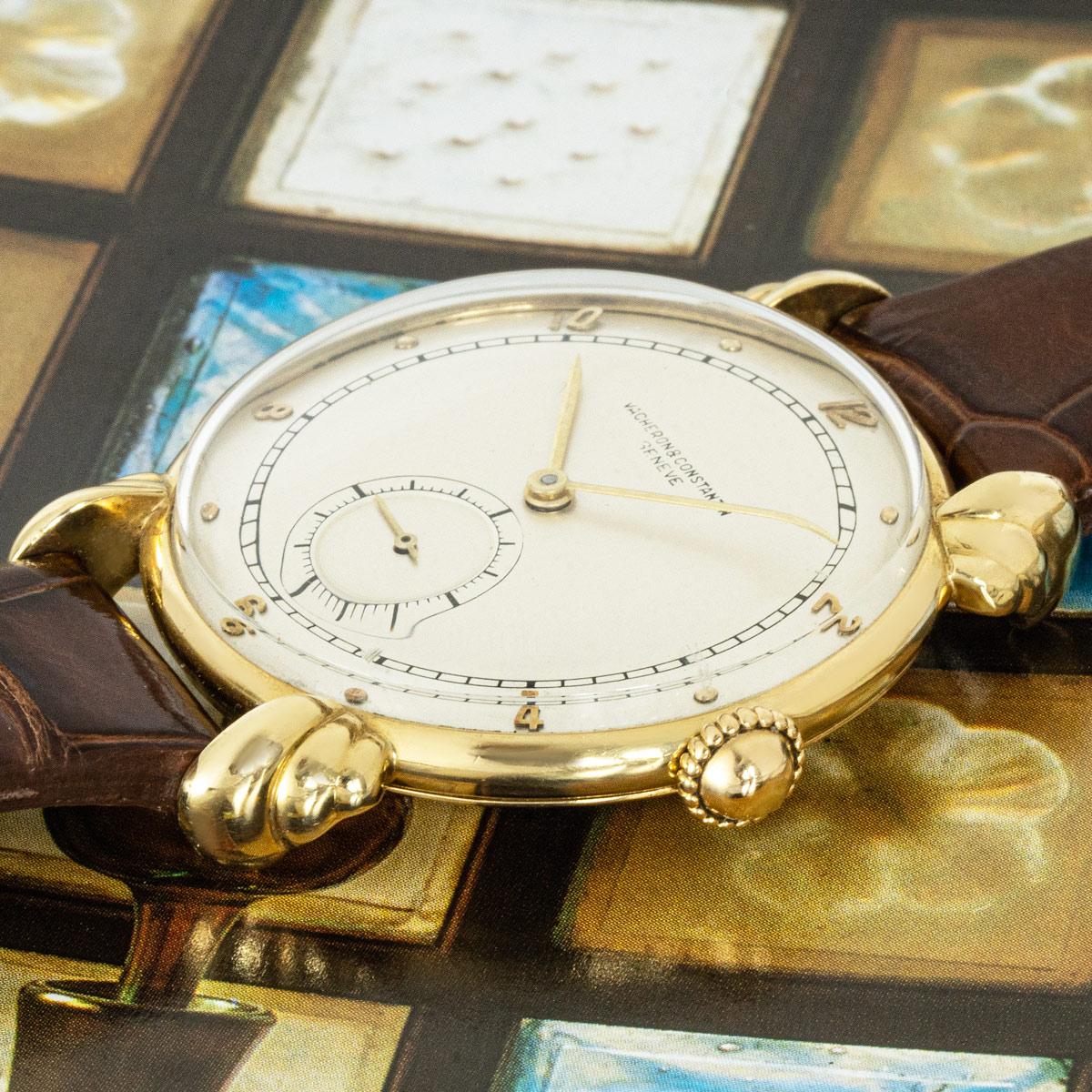 A vintage men's dress wristwatch in yellow gold by Vacheron Constantin. Featuring a silver dial with a small seconds display at 6 o'clock and fancy lugs. Fitted with plastic glass, a manual wind movement, and a new generic brown leather strap with a