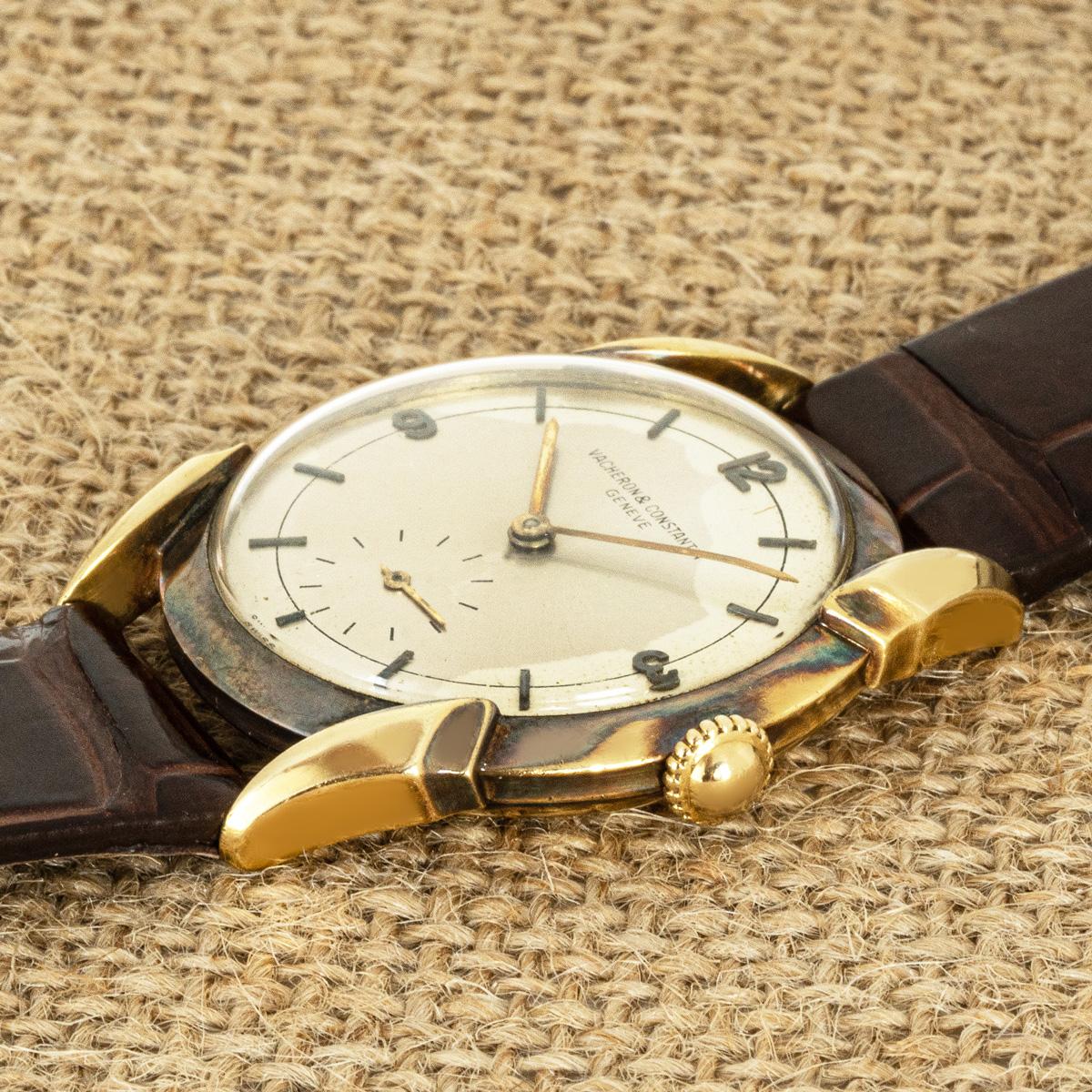 A vintage mens 34mm dress wristwatch in 18ct yellow gold by Vacheron Constantin. Featuring a silver dial with a small seconds display at 6 o'clock and Arabic numbers 3,9 & 12. Fitted with plastic glass, a manual wind movement and a new generic brown