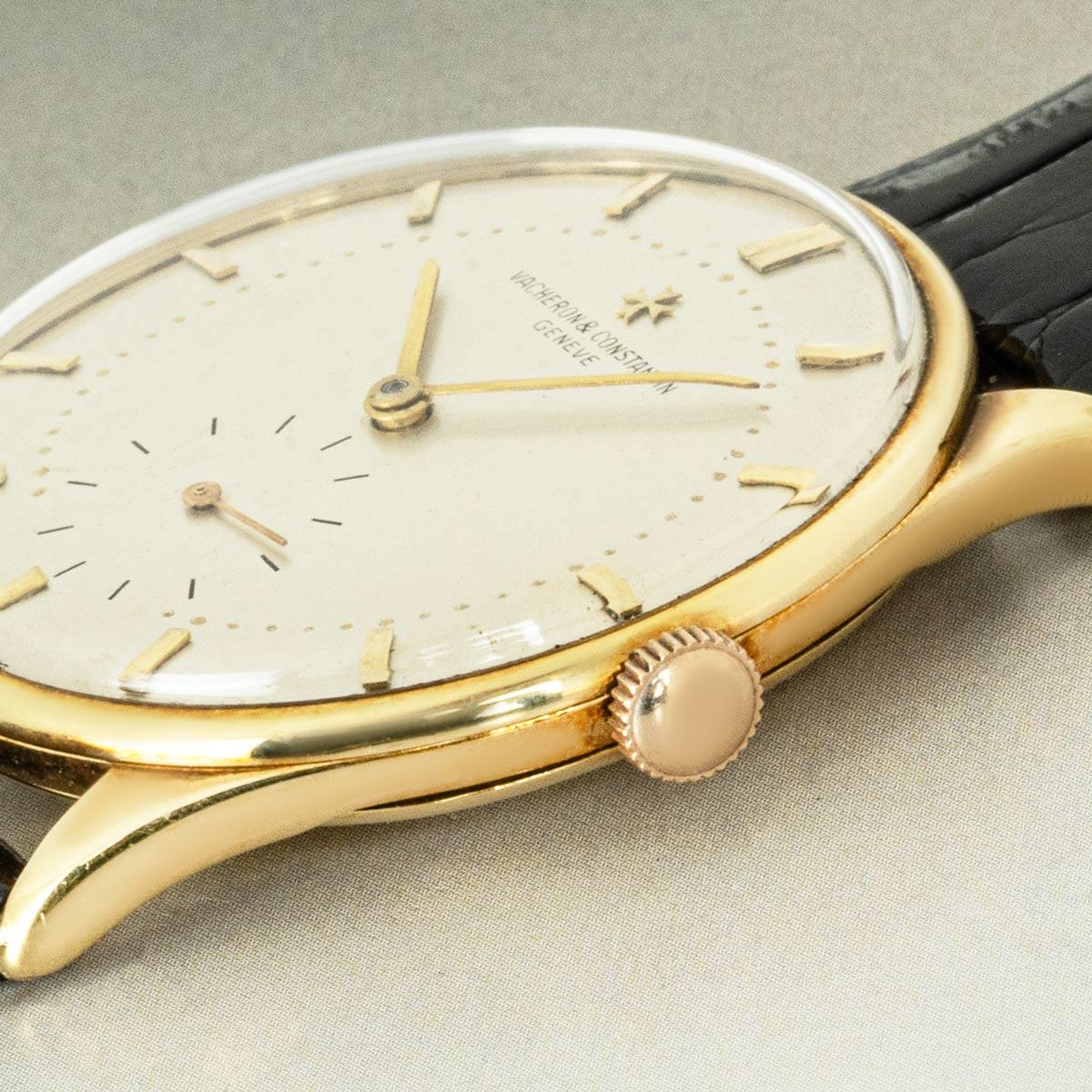 A vintage 36mm dress watch in yellow gold by Vacheron Constantin. Features a silver dial with a small seconds display at 6 o'clock and applied gold hour markers, complemented by a smooth gold bezel. Fitted with plastic glass, a manual wind movement,