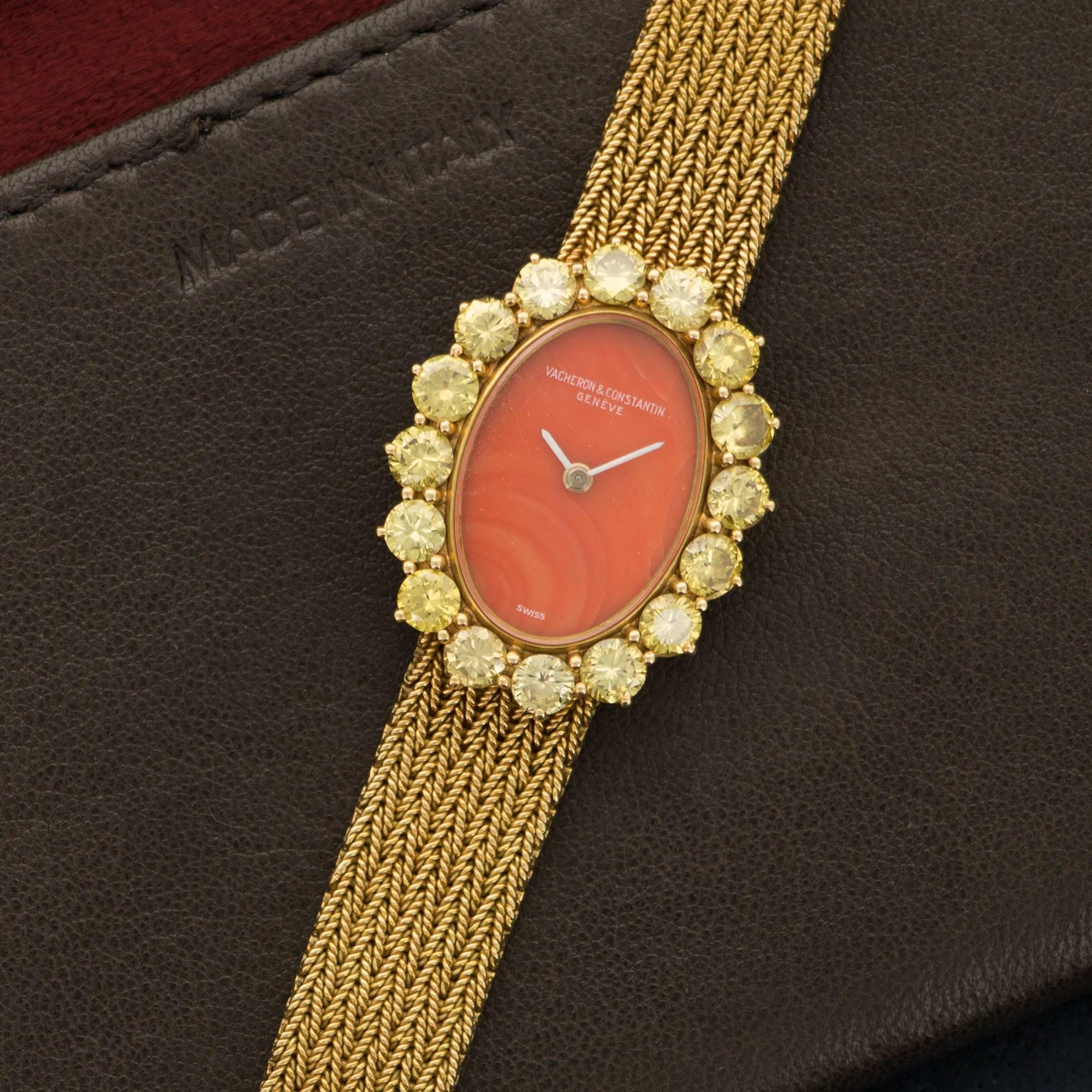 A Beautiful 18k Yellow Gold Oval-Shaped Bracelet Watch by Vacheron Constantin. Original Fancy Yellow Diamond Bezel. Coral Dial. Mechanical Wind. Case Measures 21mm X 26mm. Circa 1970's. 