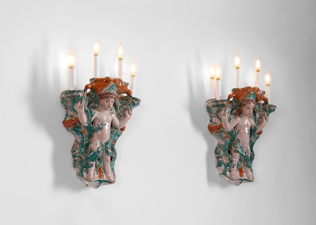 This pair of glazed earthenware sconces is a marvelous example of the work of the unique Russian-born sculptor and designer Vadim Androusov, who studied in France as Art Deco reached its maturity, and whose subjects were frequently classical in