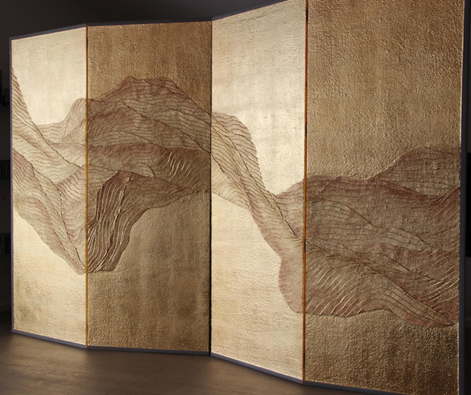 A folding screen by Vadim Garine, mixed technique folding screen painted with tempera and gold leaf, supported by a painted sanded wood frame. The screen folds in four parts standing by itself. The textured figure creates contrast between the shiny