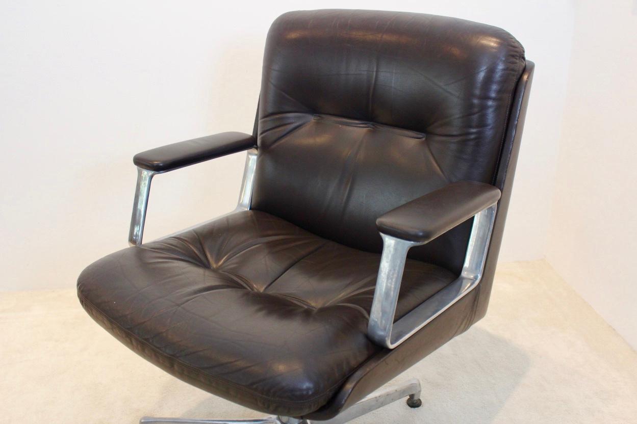 Executive office chair made by Vaghi 1960s, essentiality, simplicity, versatility. The chairs comes with swivel and ergonomic quality. The chair has very broad armrests and is height adjustable on an aluminum frame which is marked. Some slight signs