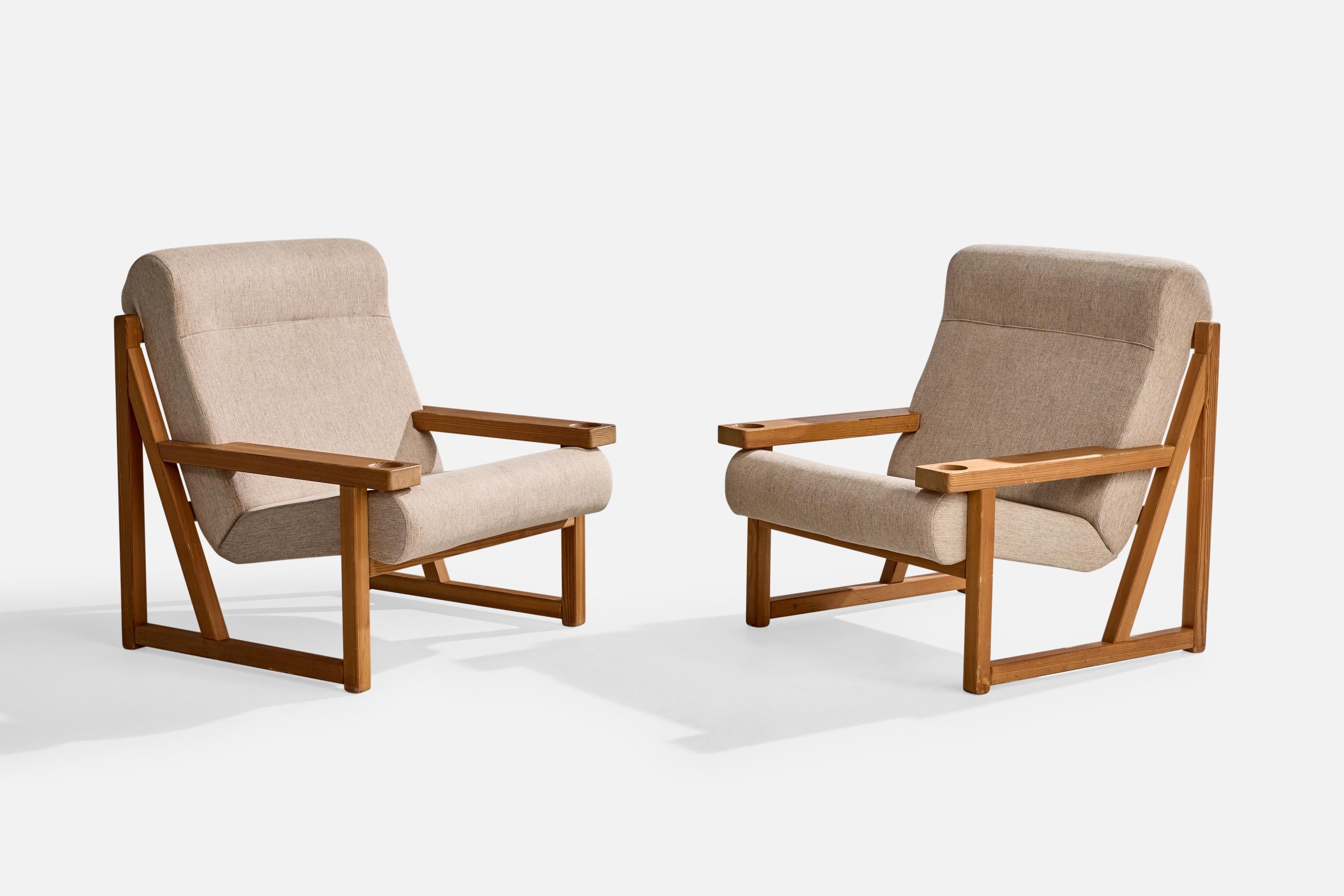 A pair of pine and light grey fabric lounge chairs designed by Vagn Fuglsang and produced by Collection Fuglsang, Denmark, c. 1970s.

Wear to wood consistent with age and use. 

Reupholstered in brand new fabric.

Overall Dimensions (inches): 35.5
