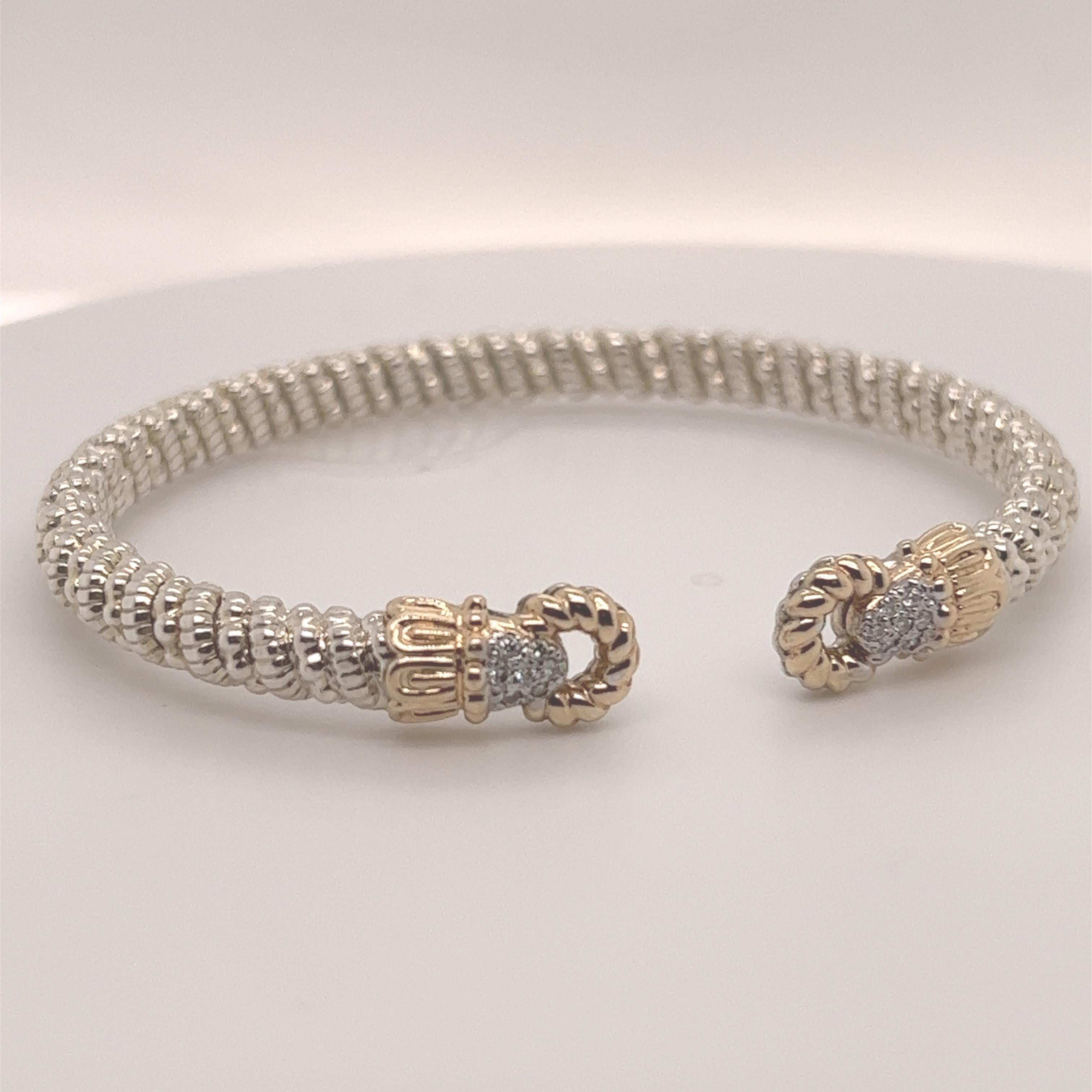 Graceful 4mm diameter open design makes it easy to slip on for any occasion, formal or casual.

Stunning sterling silver band affixed with elegant 14k gold crowns encasing 0.11 carats of brilliant round-cut white diamonds.

Style 22929D04

Includes
