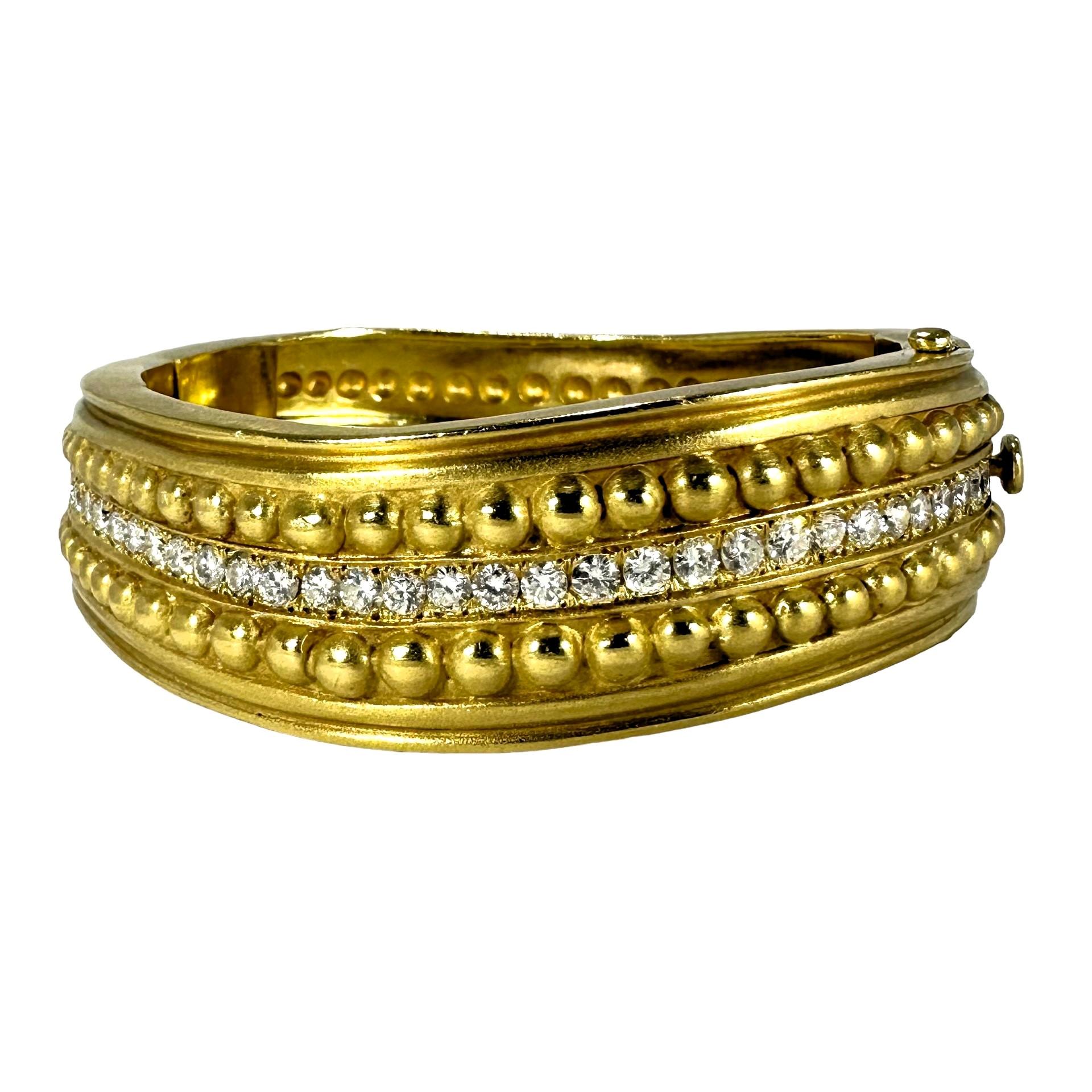 This dimensional, and substantial vintage 18k yellow gold and diamond cuff bracelet by highly regarded designer, Vahe Naltchayan is finished over all forward surfaces in a subtle satin finish. It's  slightly undulating design creates a sense of