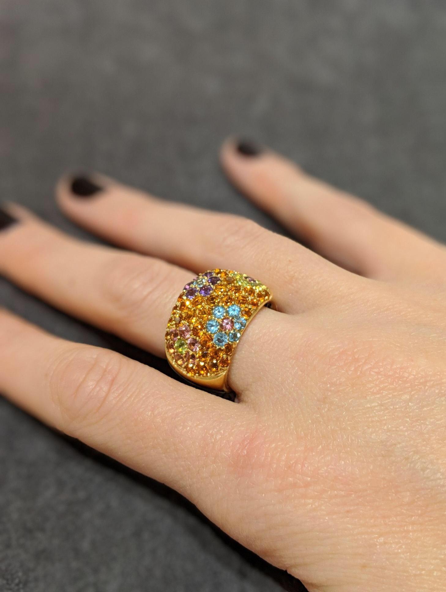 Italian Jewelers for more than three generations, VAID has produced merchandise exclusively for some of the most renowned jewelers across the world. This VAID designed 18-karat yellow gold band is set with amethyst, pink tourmaline, peridot and blue