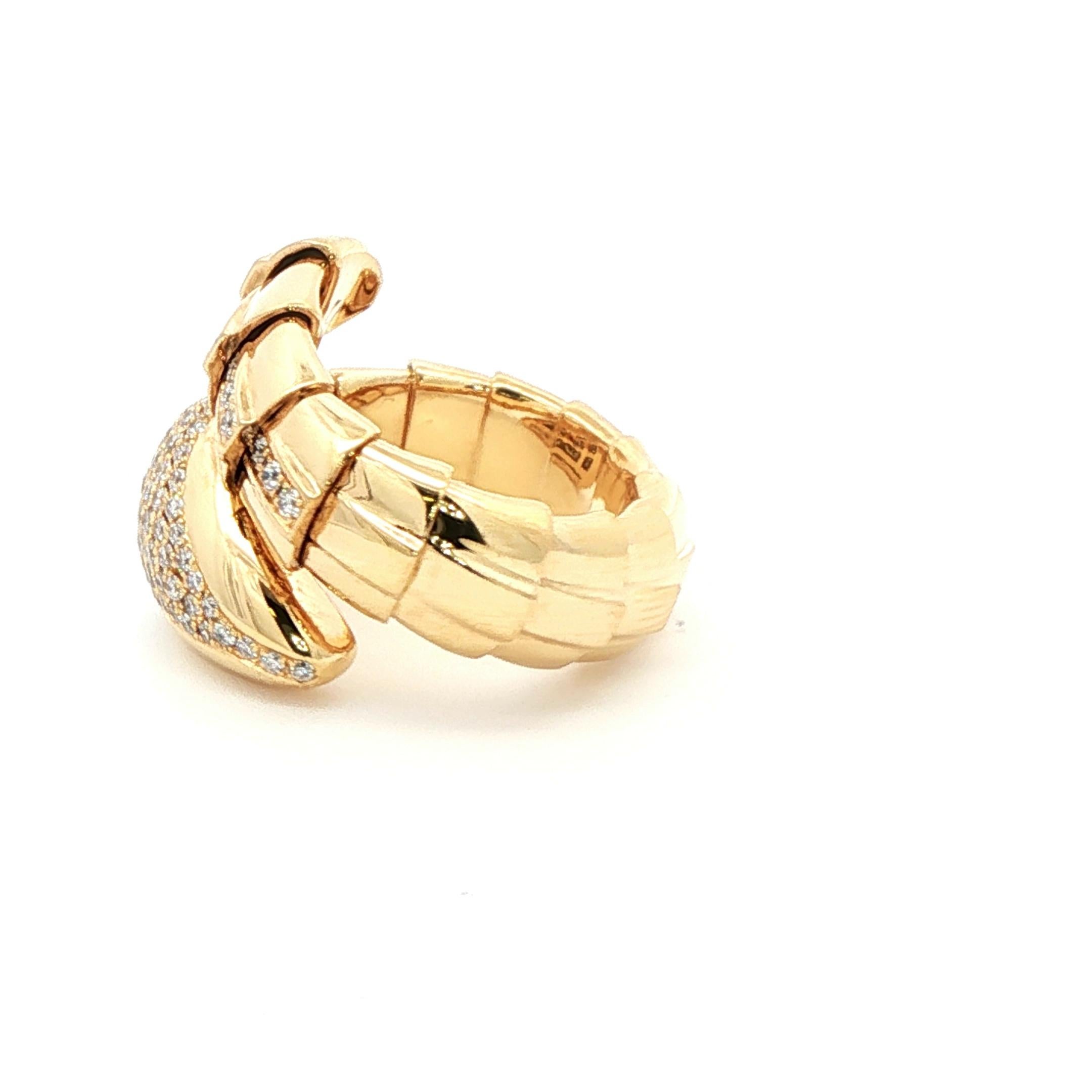 This exquisite import by Pampillonia Jewelers, designed by Vaid in Rome, is a striking example of Italian artistry. Crafted in 18kt yellow gold, the ring features a sculptural, snake-inspired design that wraps gracefully around the finger. At its