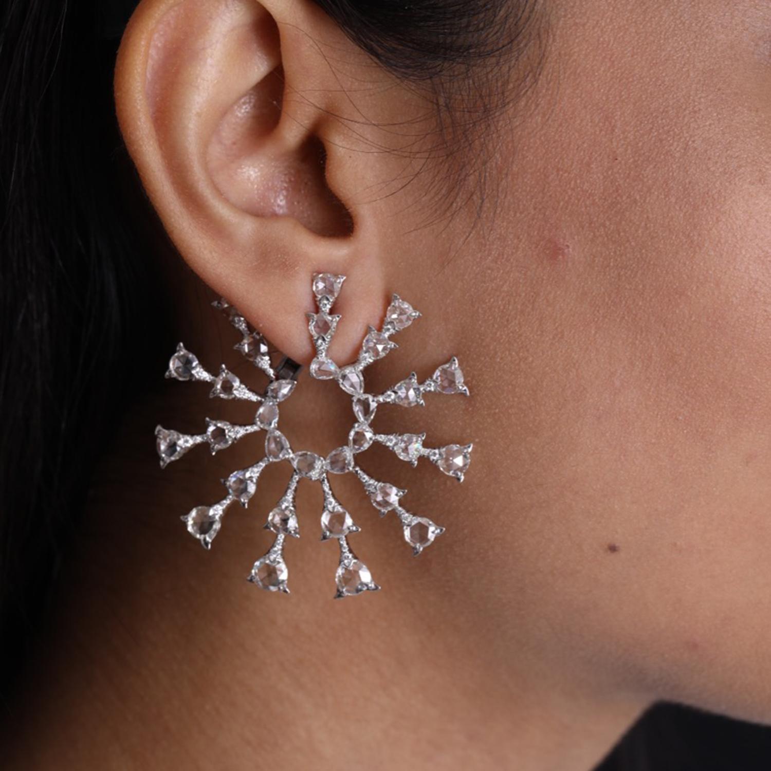 Inspired from nature  , these earrings  are made with  V.A.K. Jewellery's signature engineering which uses minimal metal.
The round  rose cut diamonds  are set to look  like floating petals hanging from a tree branch .  The design is bespoke ,