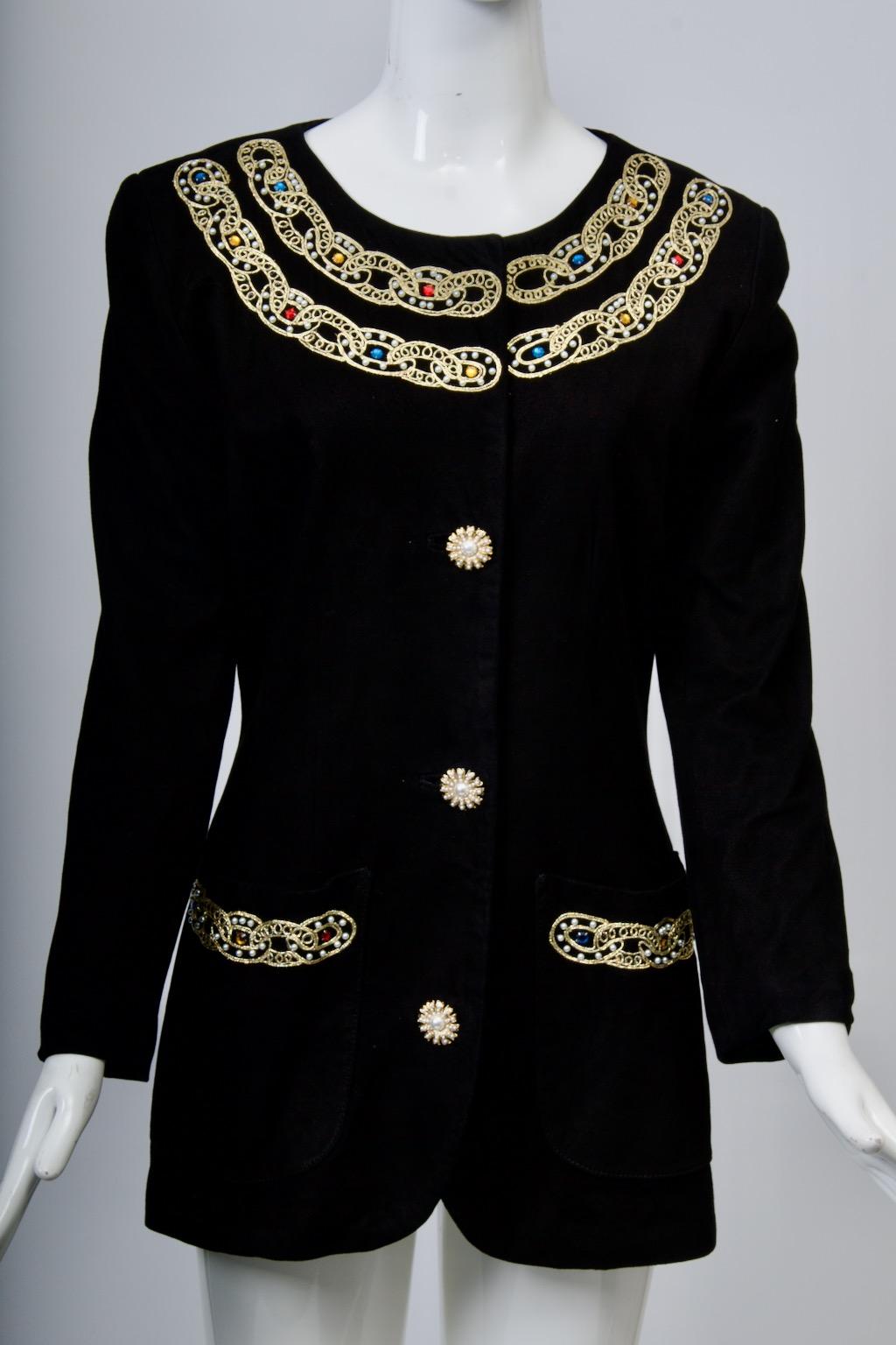 Vakko black suede jacket embellished with gold braid interspersed with multicolor  gems is a showstopper. The long, shaped jacket hits below the hips and features an open neckline trimmed with two rows of the gold braid/stone embellishment, as are