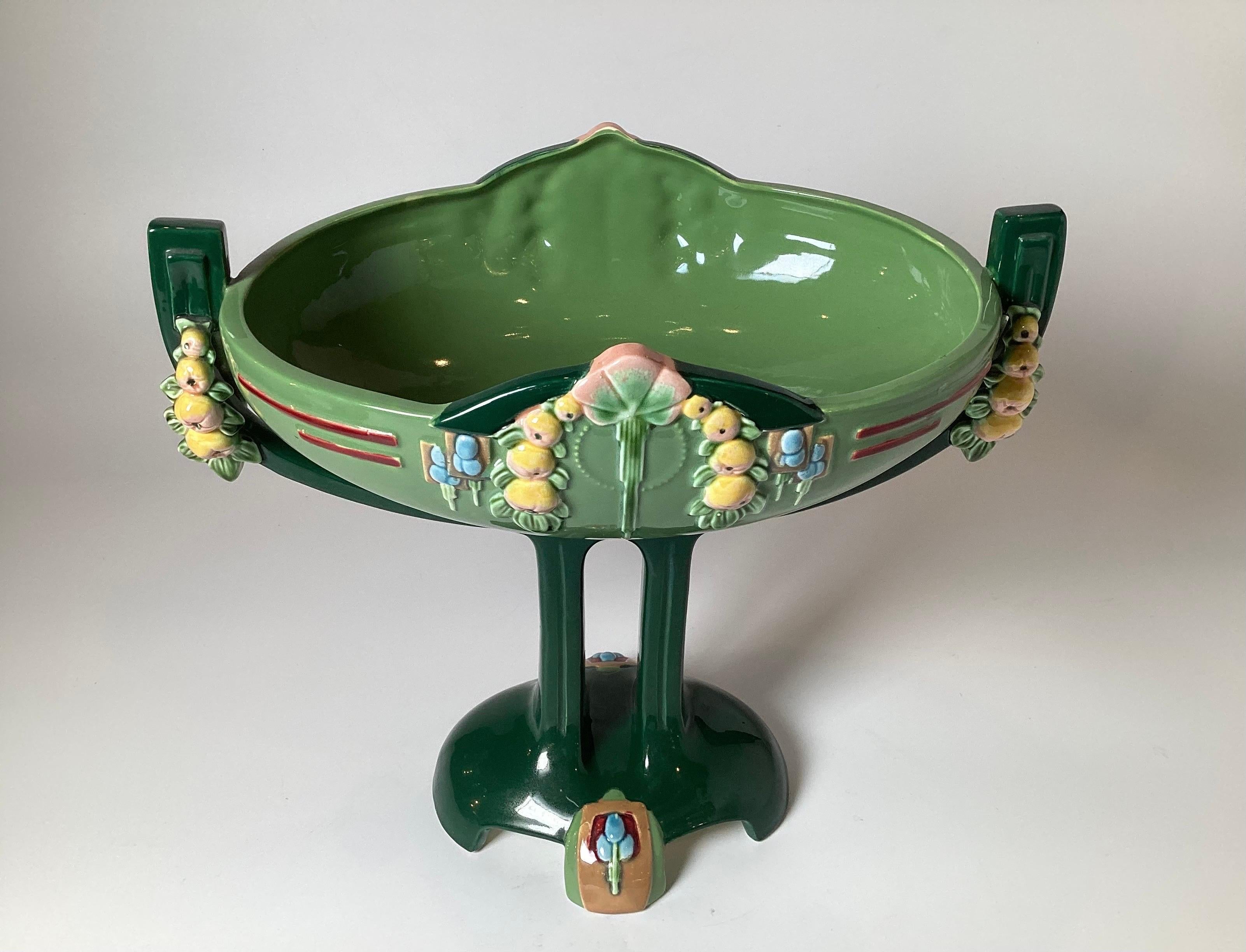 Beautiful Art Deco vibrantly colored oval compote centerpiece from around 1920. The apple green glaze in a bit of an Art Nouveau influence, made in Europe, Czechoslovakia with hand painted glazed details, measuring 13.5 inches high, 15 inches wide,