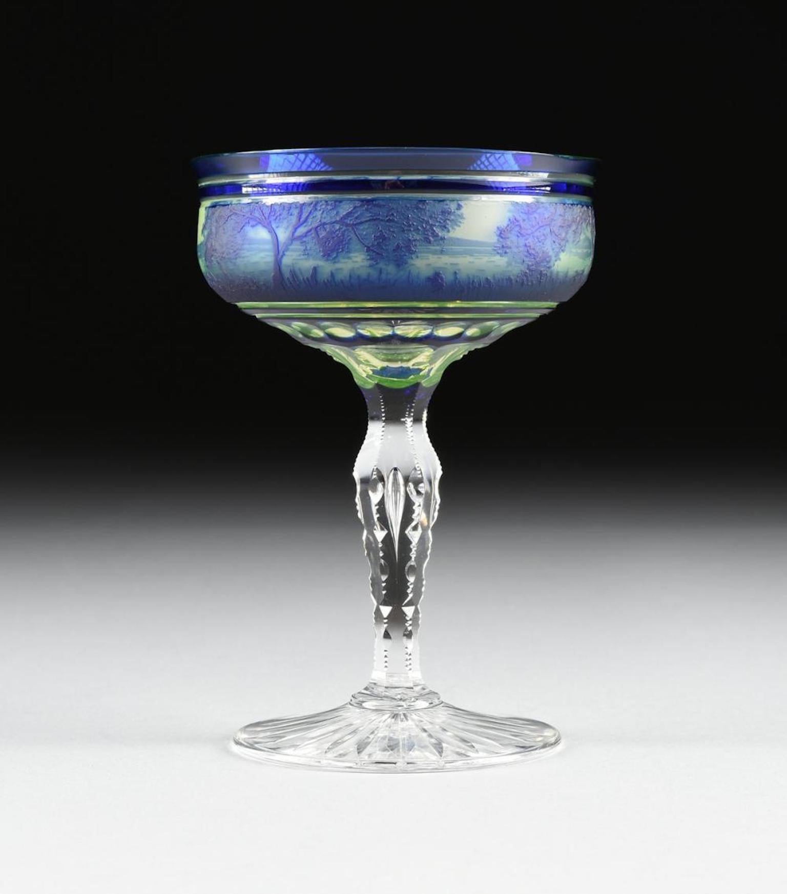 Seraing, Belgium, circa 1900, the coupe form bowl with everted lip in cobalt blue cut to citrine cut to clear, with a band of cameo landscape decoration between cobalt bands with a band of reserved circular cuts at the base, raised on faceted