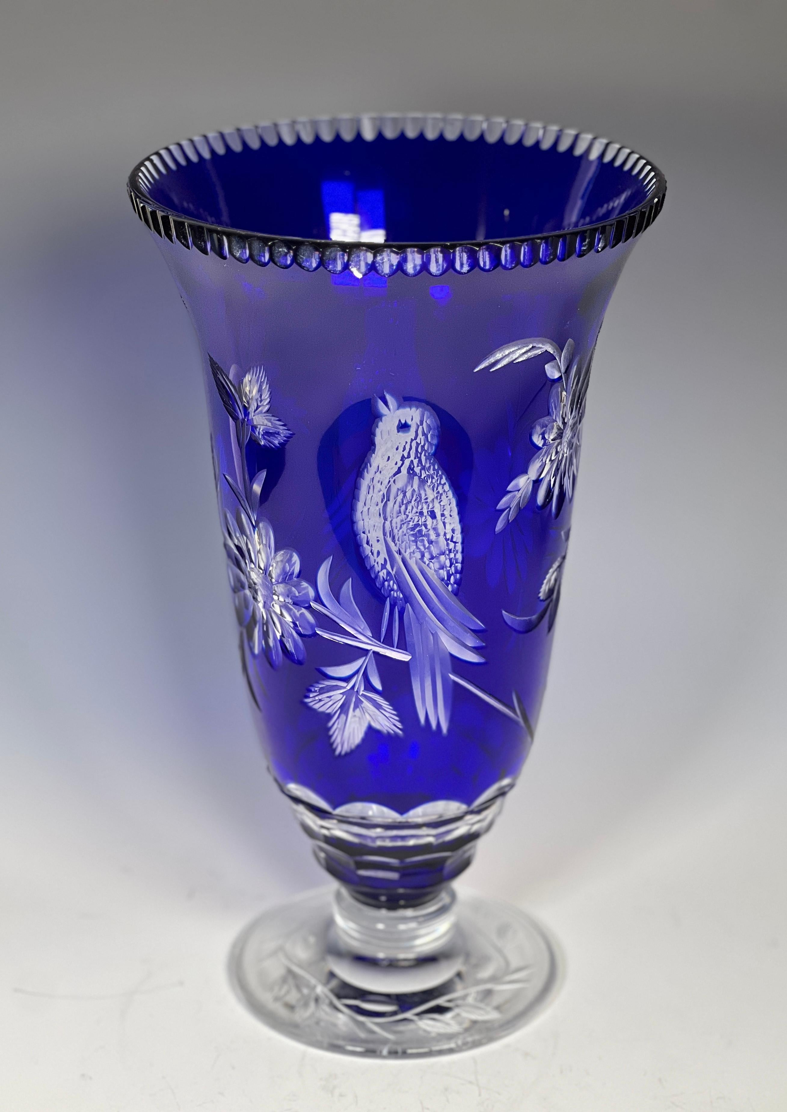 This Val Saint Lambert vase is a rare example of a pattern that was only used for goblets and most likely a custom order. It is hand blown crystal with cobalt blue overlay cut to clear, depicting a combination of birds and flowers. This vase stands