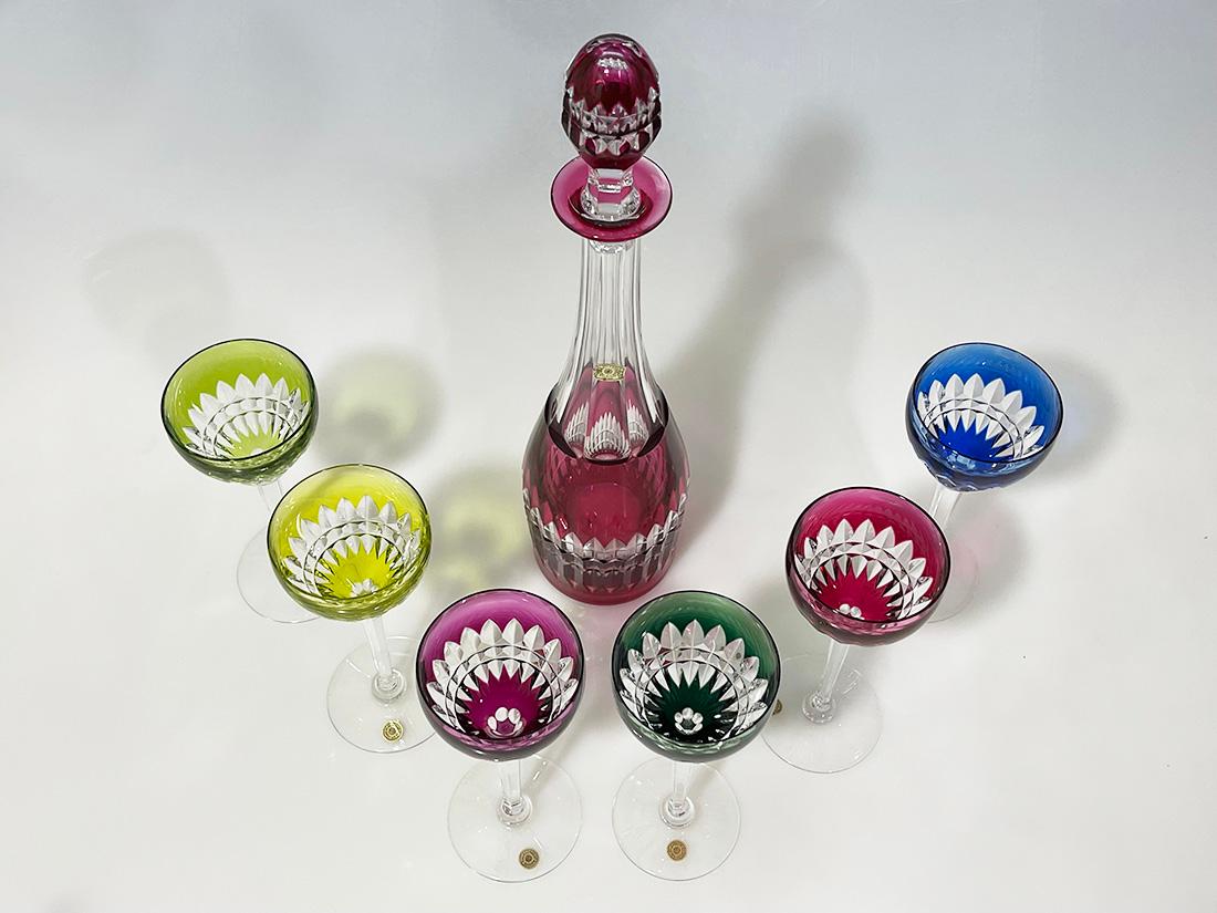 Val Saint Lambert colored cut-to clear crystal wine set, signed

A set of a decanter with six wine glasses in the colors from olive green to emerald green, pink, and blue cut to clear crystal glass from Val Saint Lambert, Belgium, established since