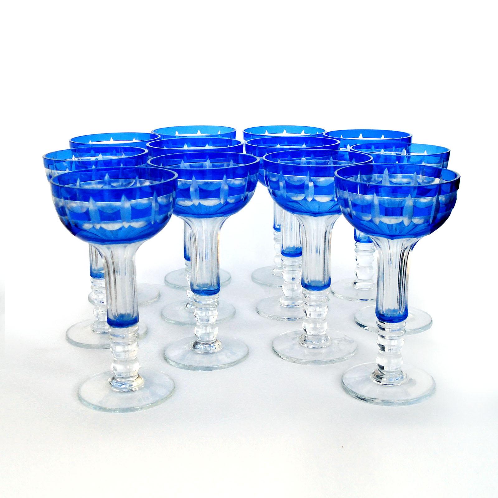 A set of 12 entirely hand-made blown crystal goblets with cobalt blue overlay cut to clear with clean geometric decoration. The shape is lovely to hold, a rounded body with a hollow stem on a well-proportioned base. It could be used for champagne or